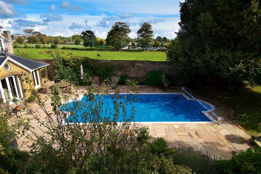 The swimming pool and patio offer opportunities for enjoying the summer