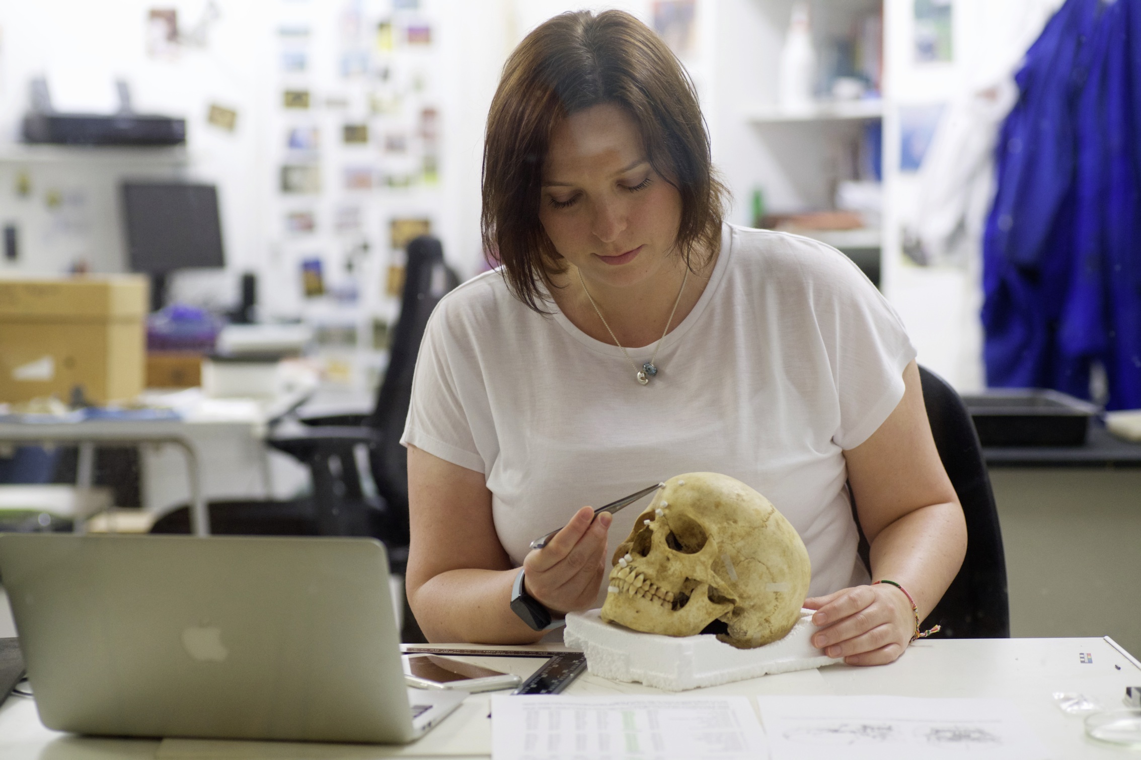 Human Osteologist Rosalind Le Quesne working on a skull belonging to a 15 year old female that was unearthed during excavation work 
