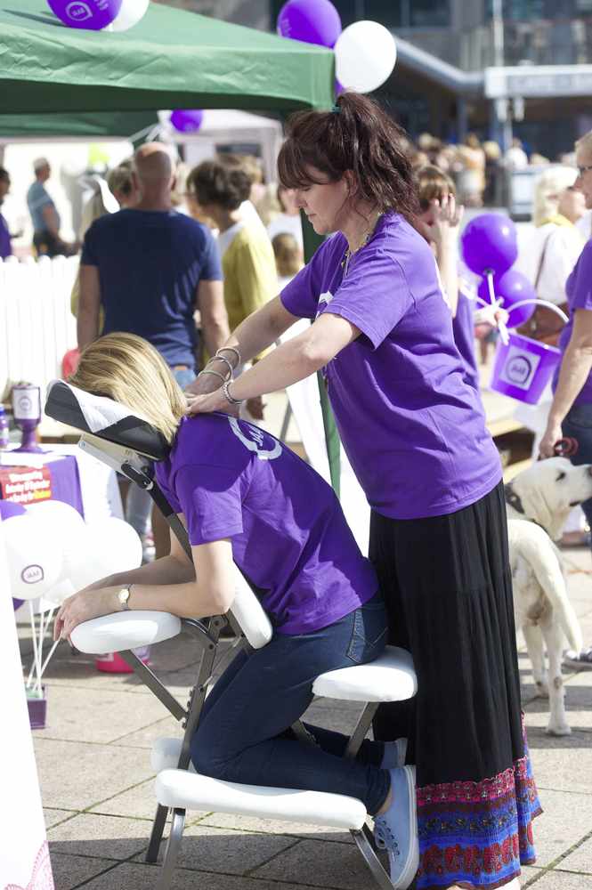 Natalie Fisher from Matisse Hair and Beauty giving a massage to Nina Jensen in aid of JAAR.