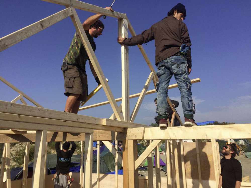 Work on the permanent shelter in Calais which is being built with timber from Normans