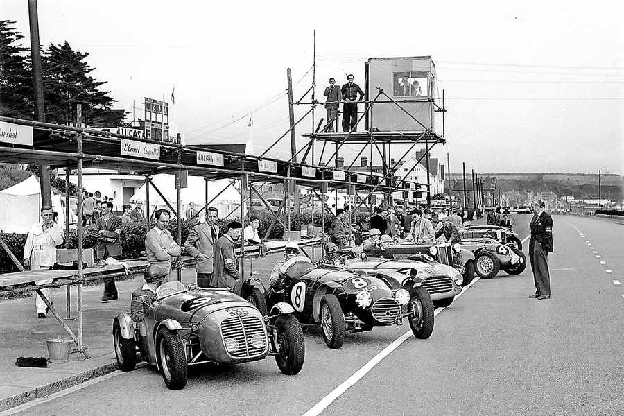 Cars waiting in the pits below the commentator's box, 1952