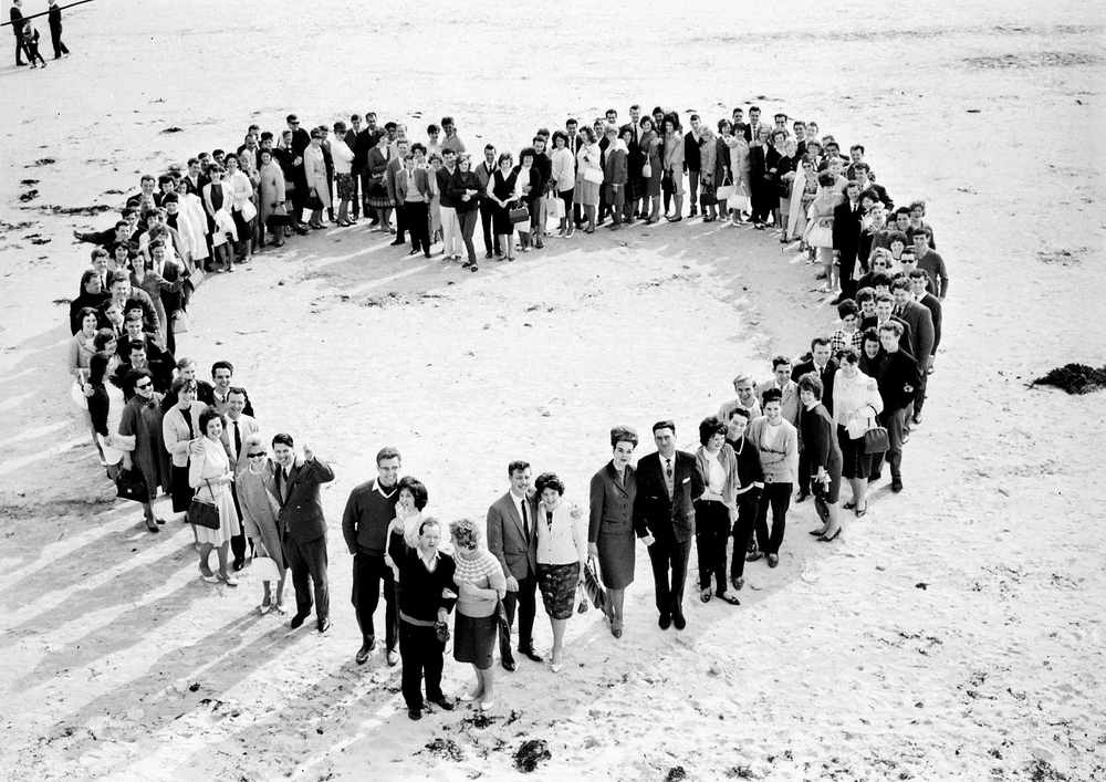 Honeymooners form a heart on St Brelade's Bay in 1964