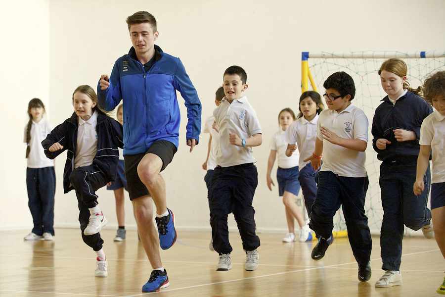 Iolo Hughes, a member of Team GB, leads the high knee drills at First Tower