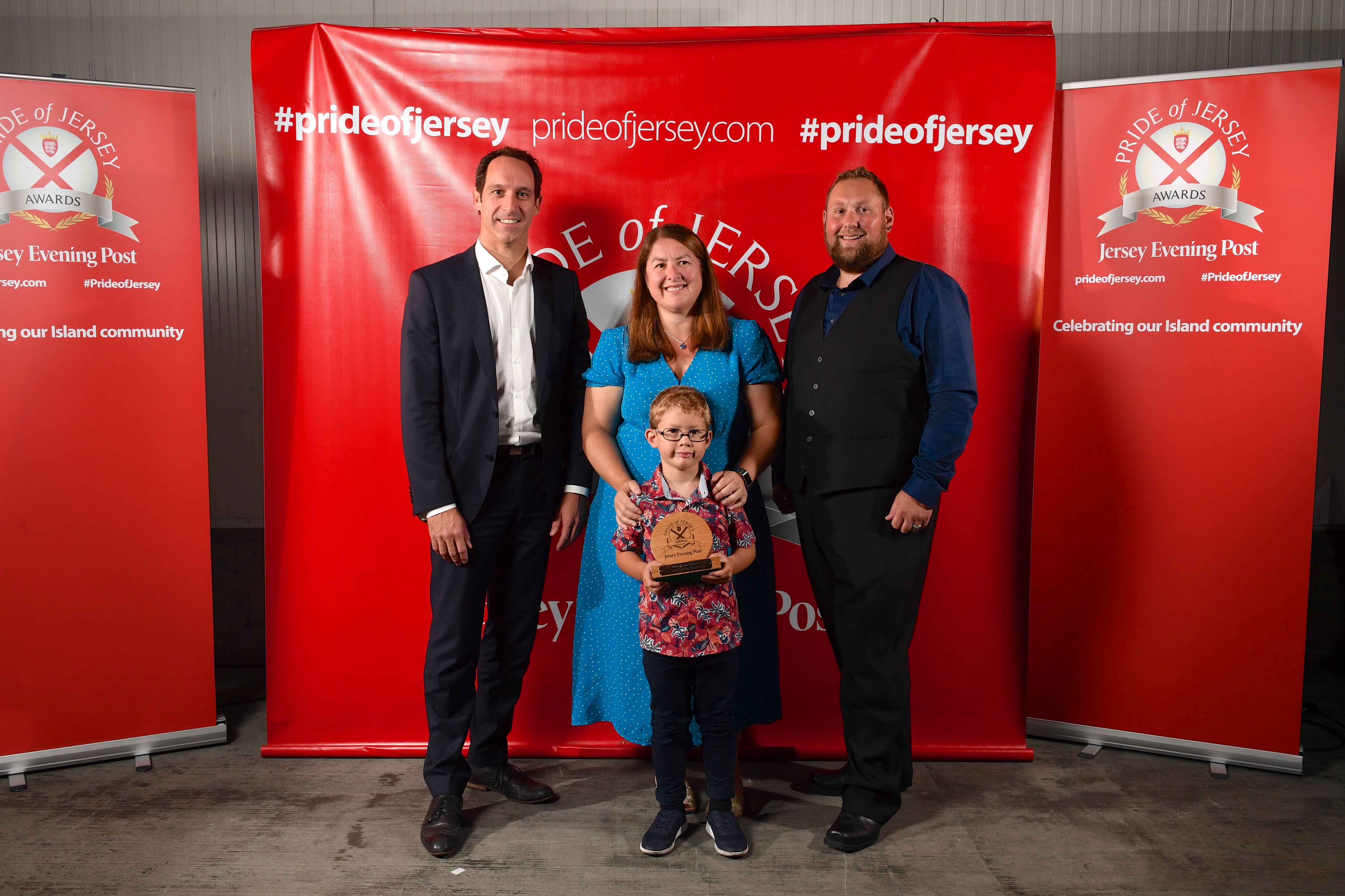Child of the Year winner Jake Hutchings with his parents, who won Neighbours of the Year, pictured with Lee Henry from sponsors the JDC (left)..Picture:DAVID FERGUSON. (26390021)