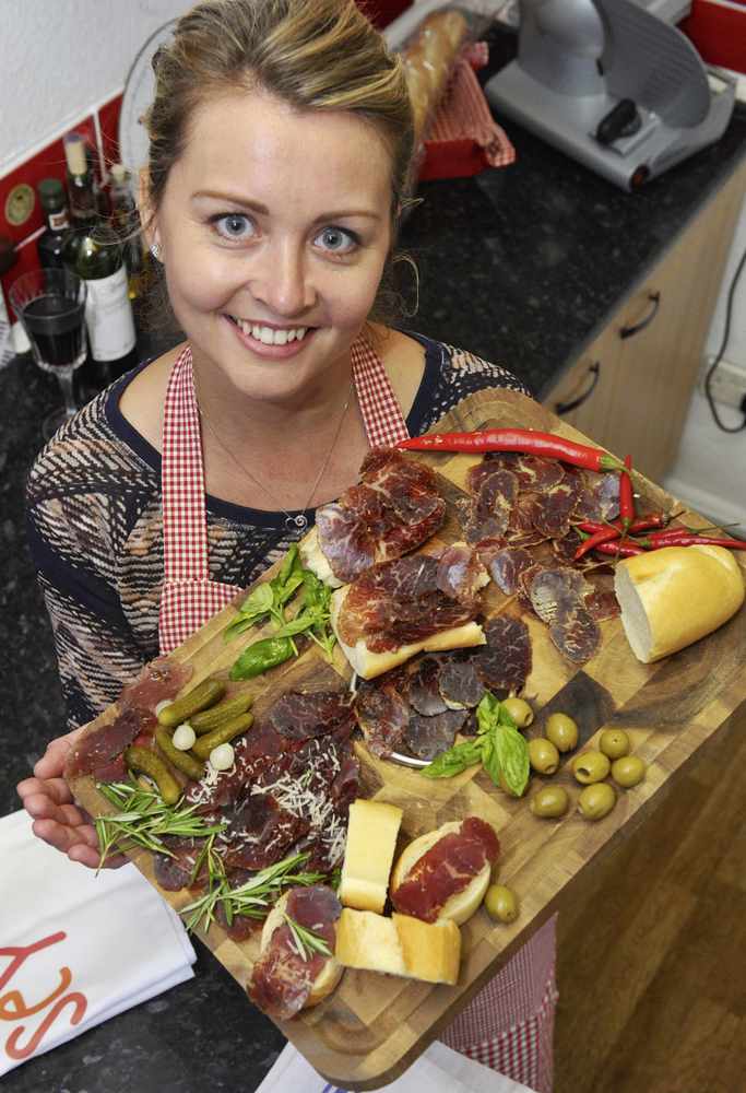 Georgina Reid with an antipasti platter of her Jersey Cured beef, which carries its own logo