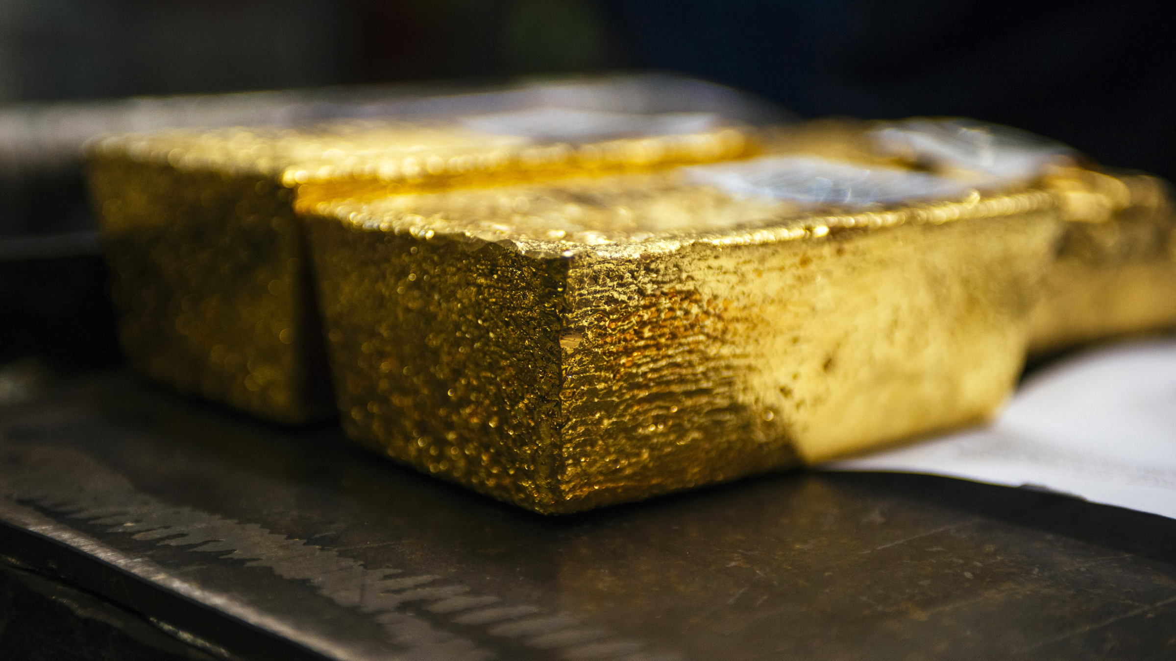 Gold bullion bars sit following casting at a refinery.