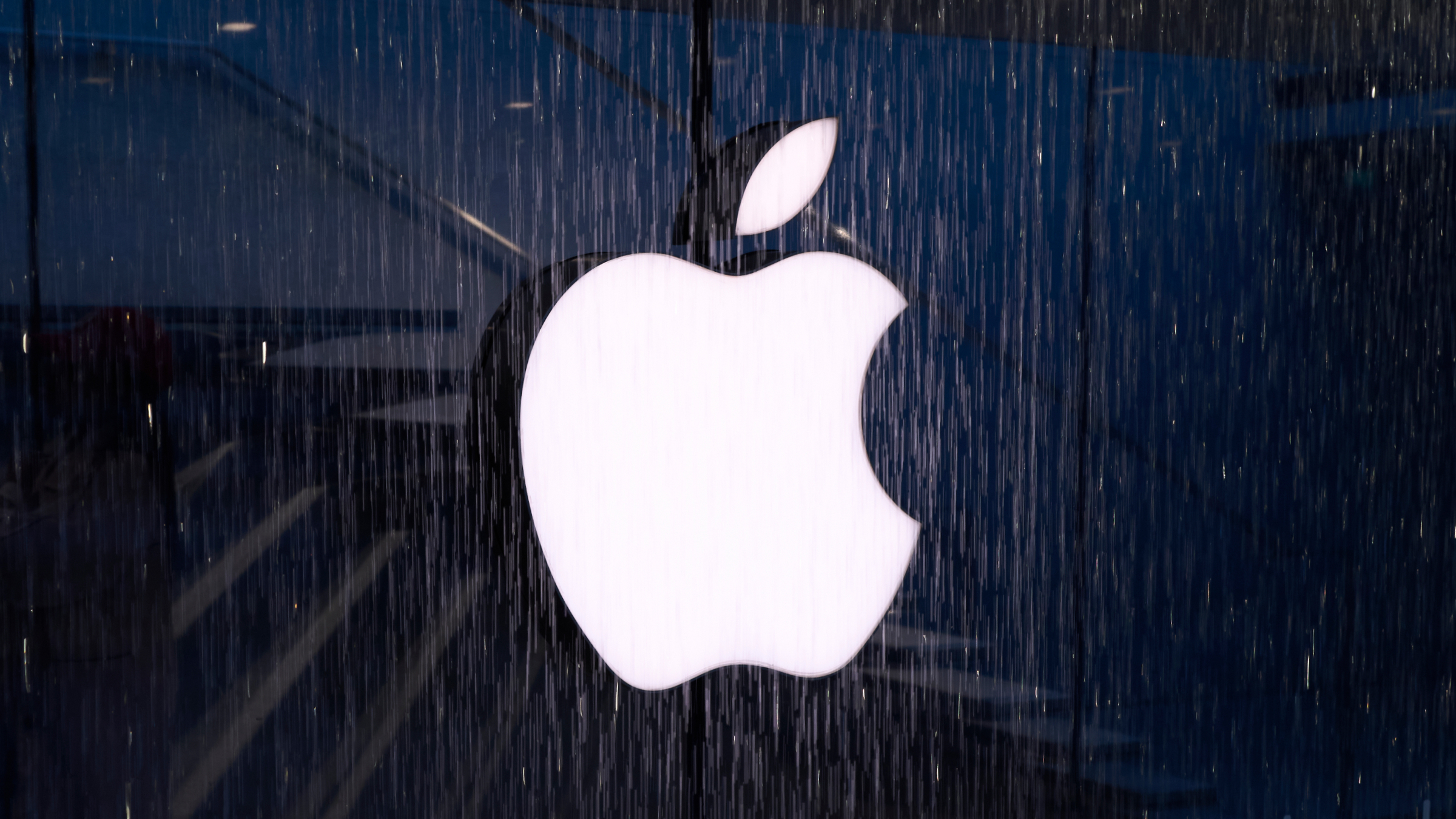 The Apple logo is visible on the water curtain glass facade.