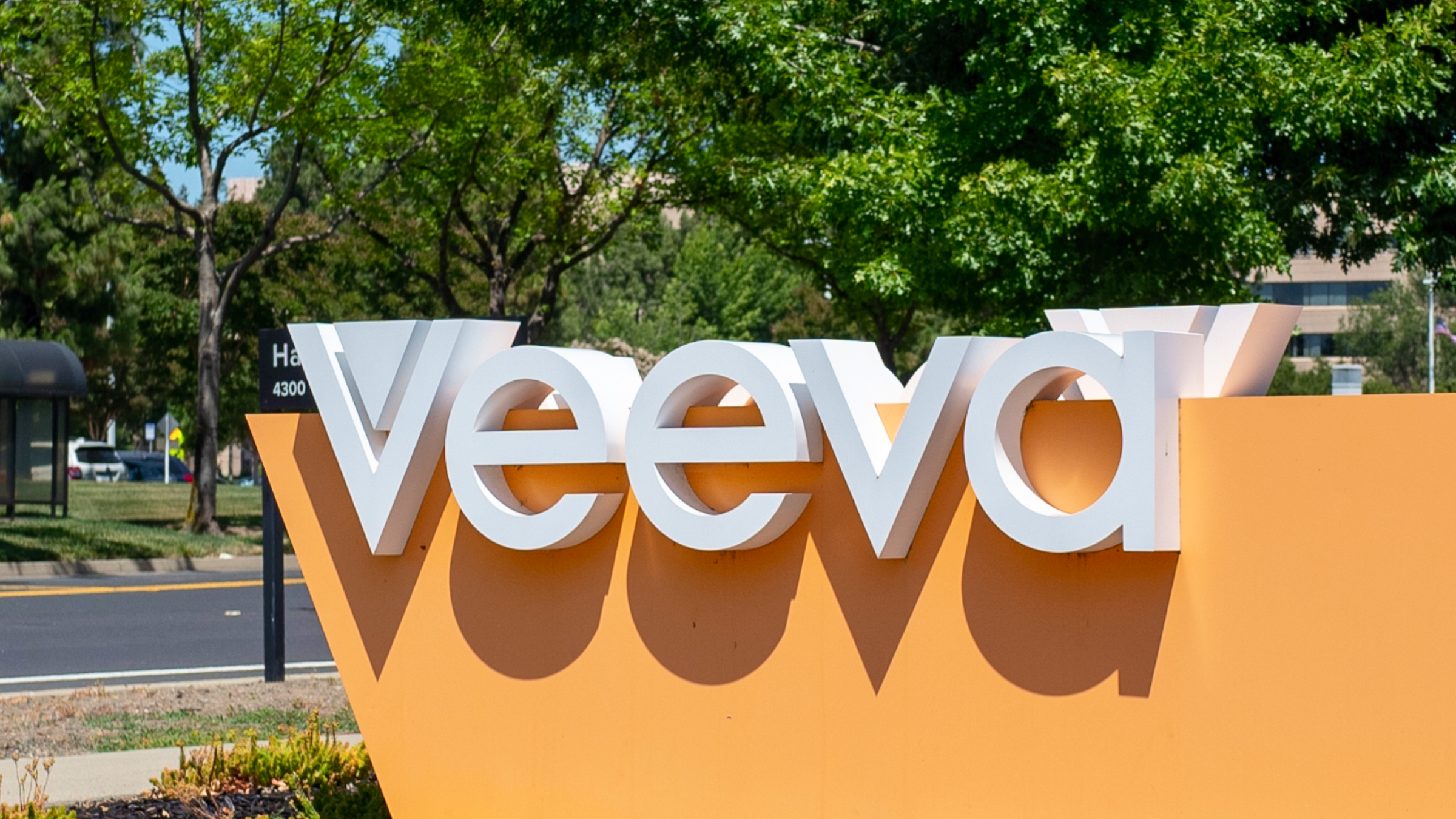 Signage of Veeva logo in front of an office building.
