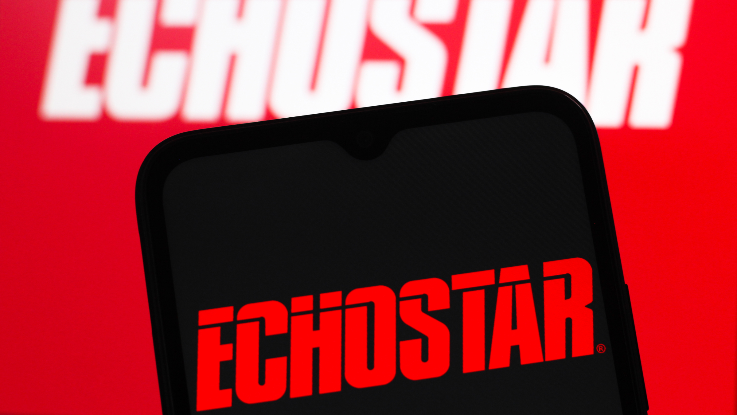 In this photo illustration, the EchoStar Corporation logo is seen displayed on a smartphone screen.