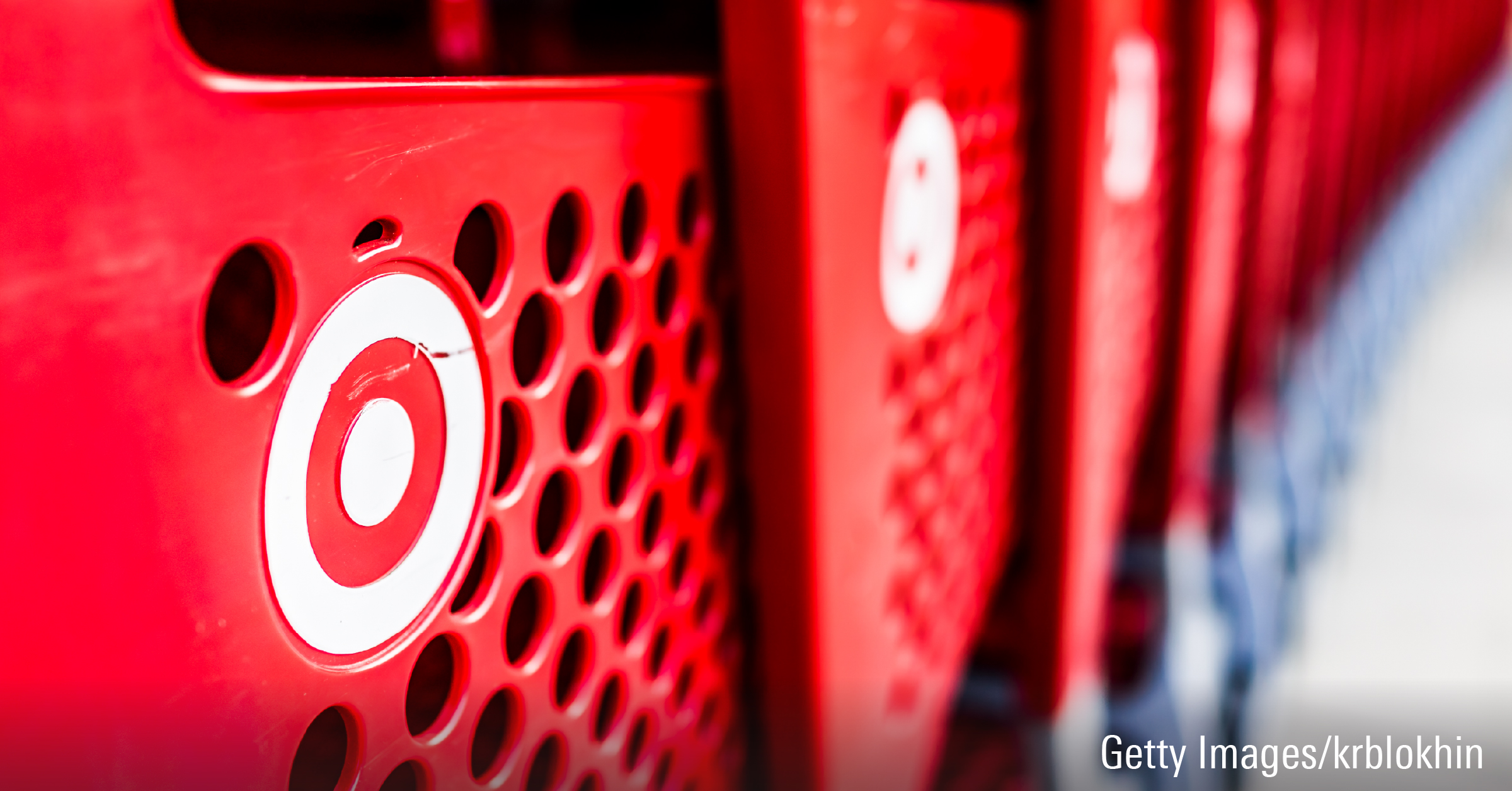 A row of shopping carts with the Target store logo are shown stacked together.