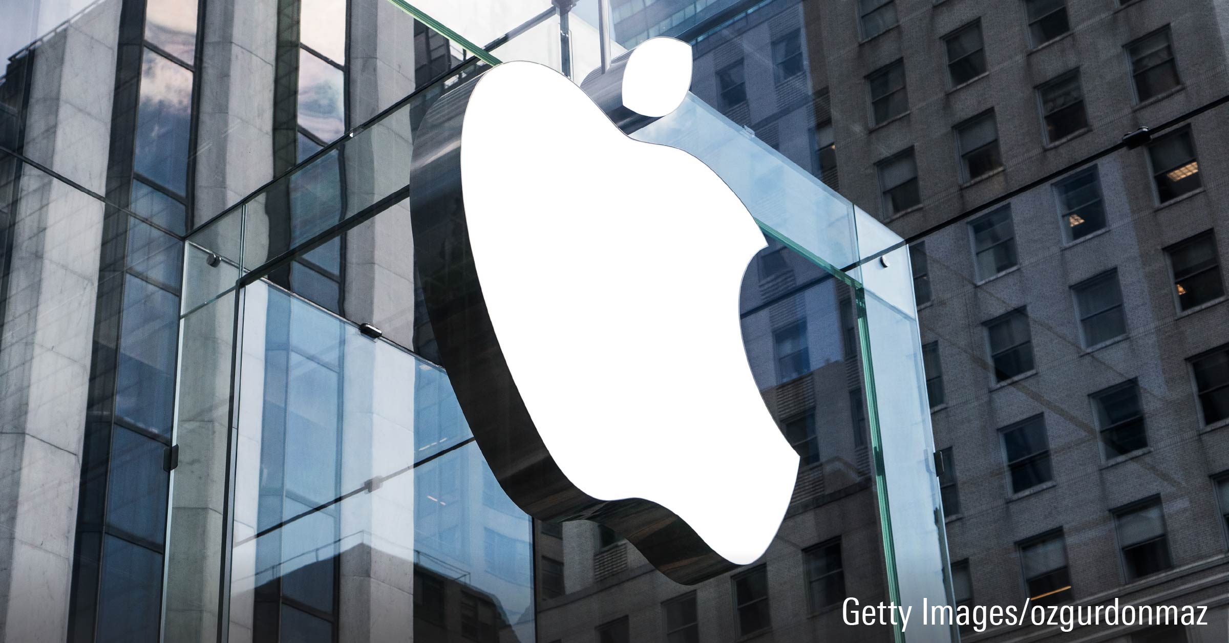 Apple logo icon displayed on window glass of building