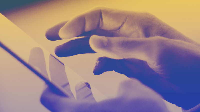 Photograph of a hand using a cellphone