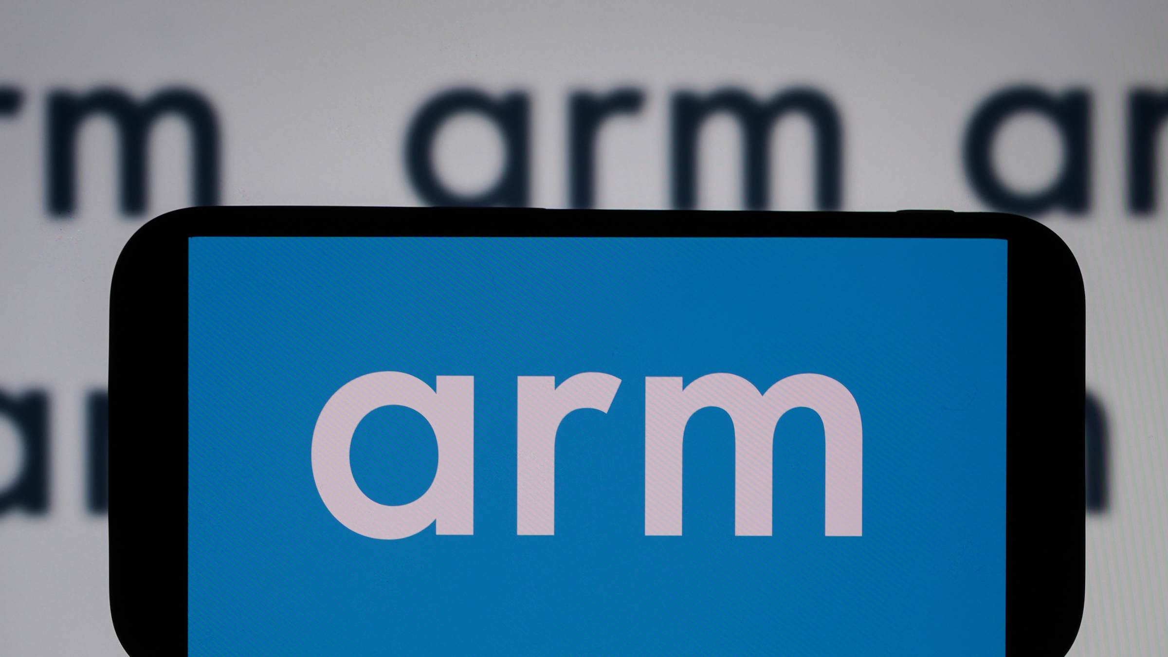 The arm logo is displayed on a mobile phone screen.
