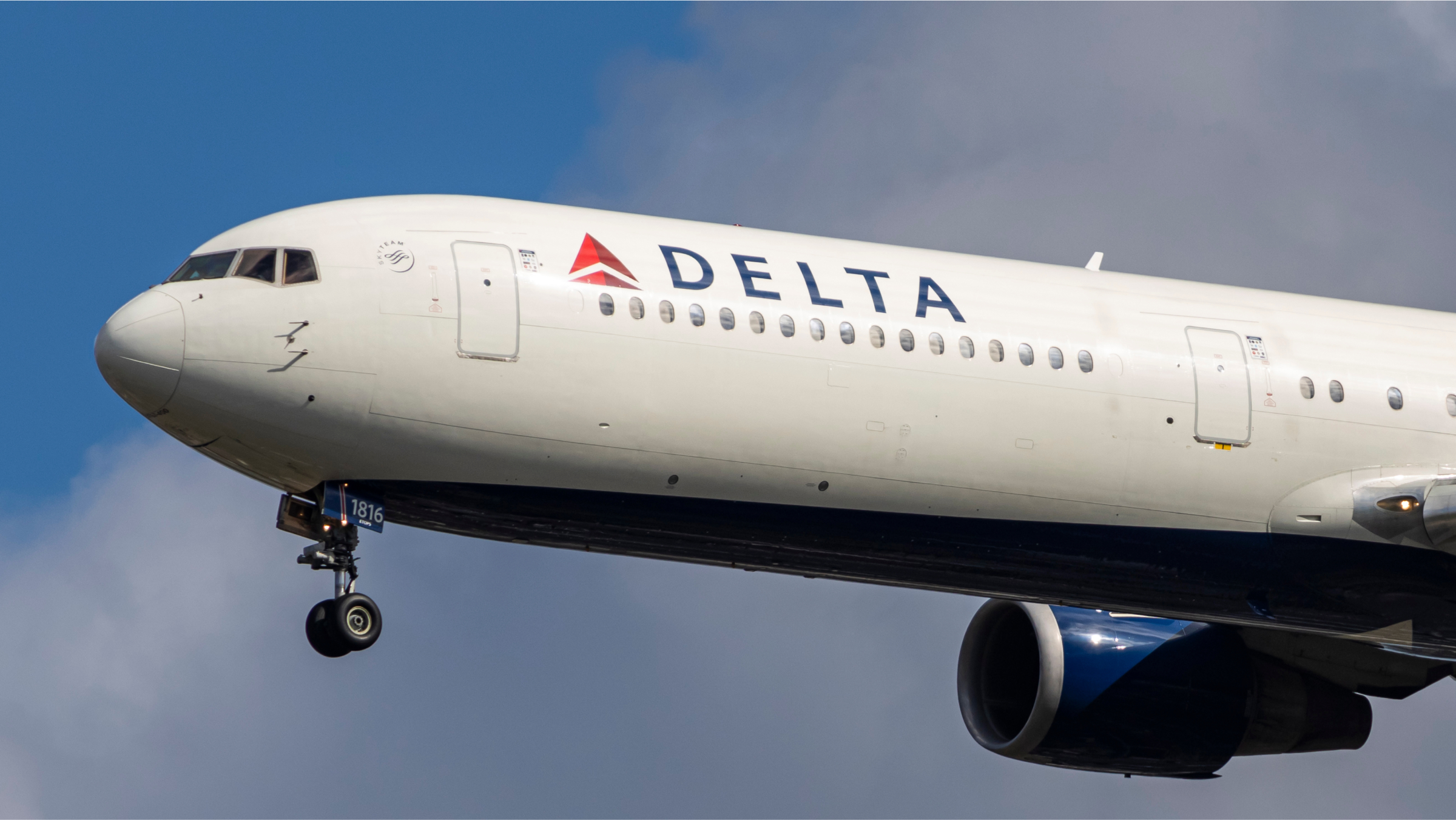 Delta Air Lines aircraft spotted on final approach flying before landing on a runway.
