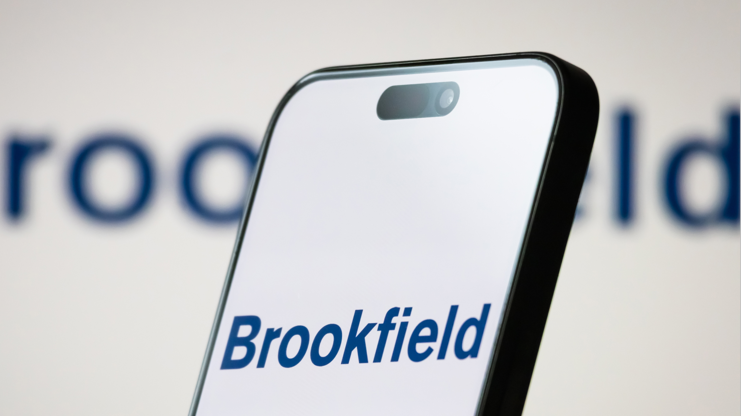 The logo of Brookfield Corporation is displayed on a smartphone screen.