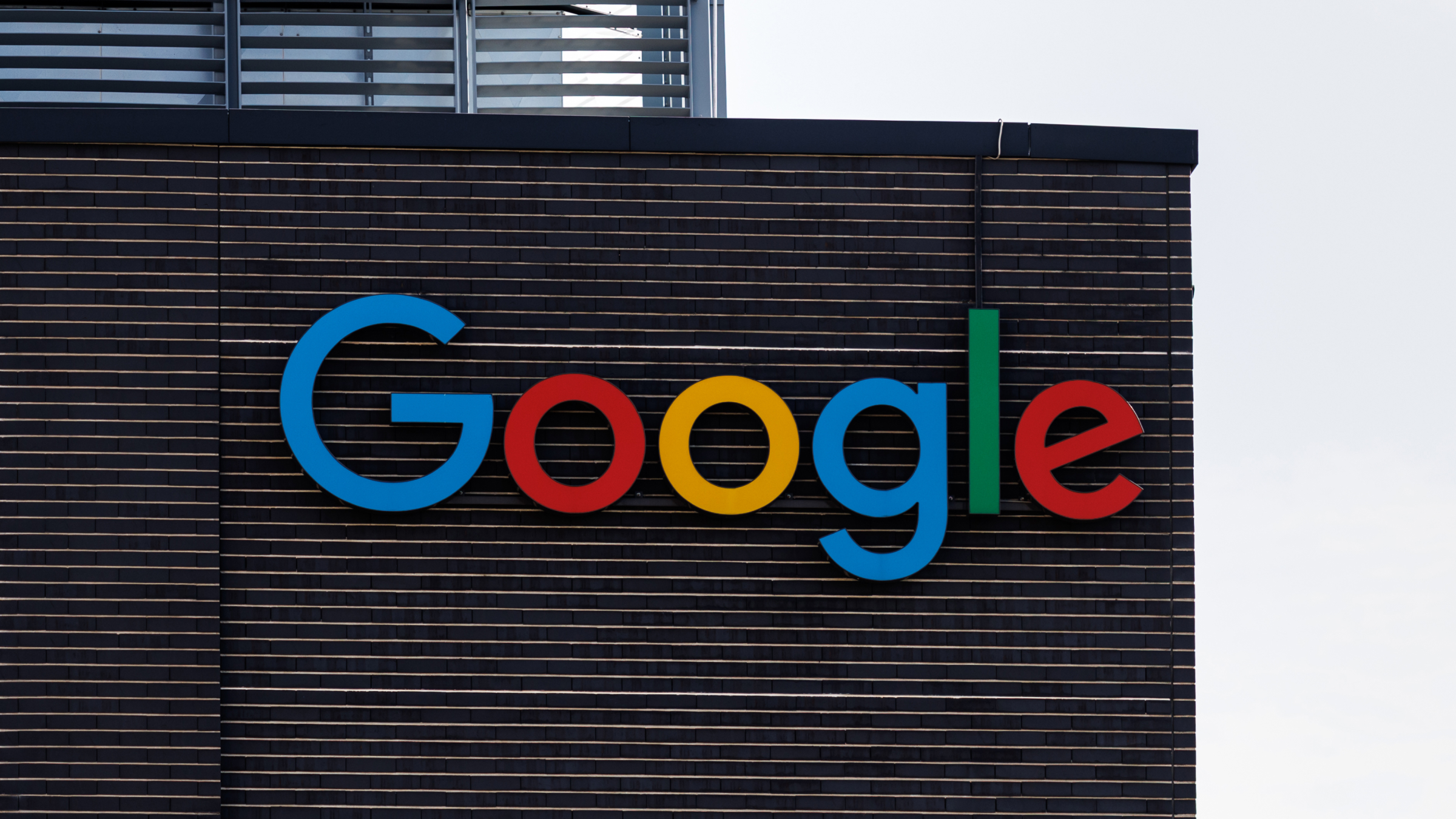 The Google logo on a facade of a headquarter building.