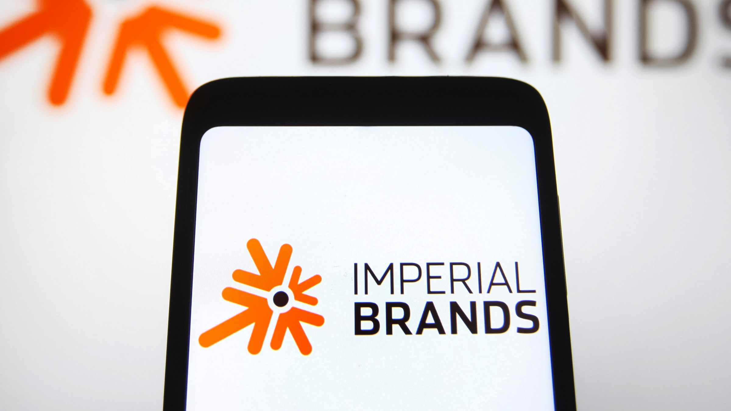 An Imperial Brands plc logo is seen on a smartphone screen.