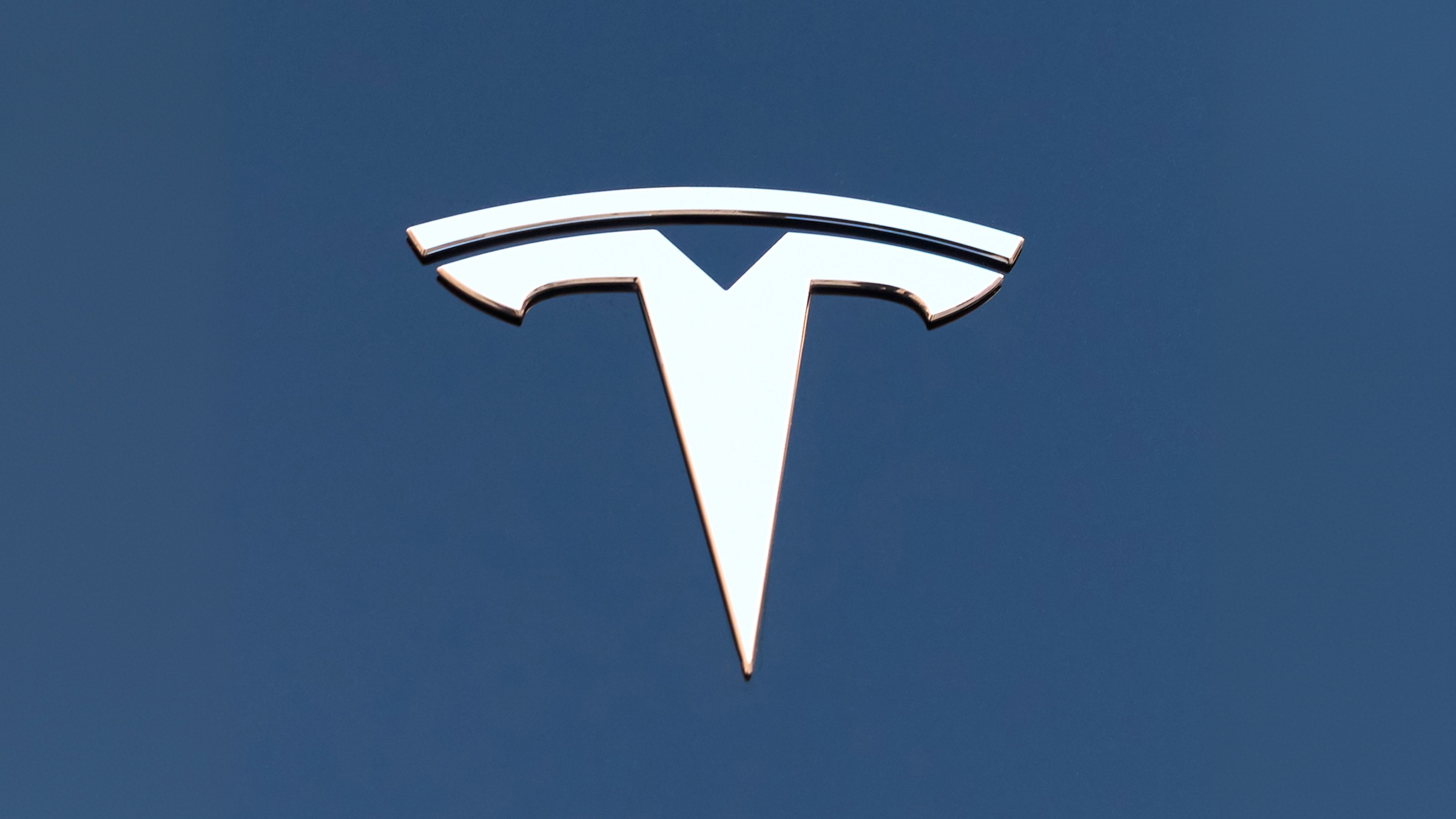 The Tesla logo is displayed on the hood of Model 3 electric car.