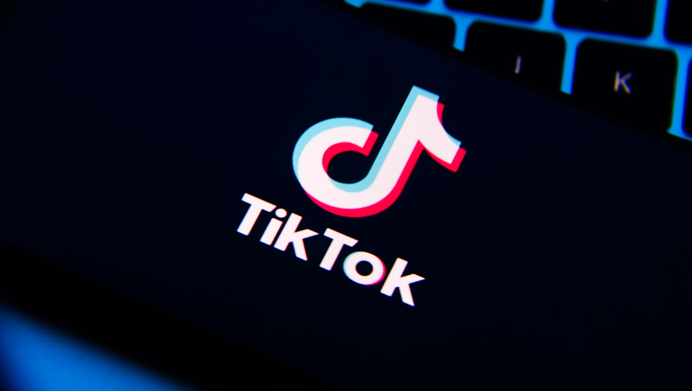 TikTok logo is screened on a mobile phone.