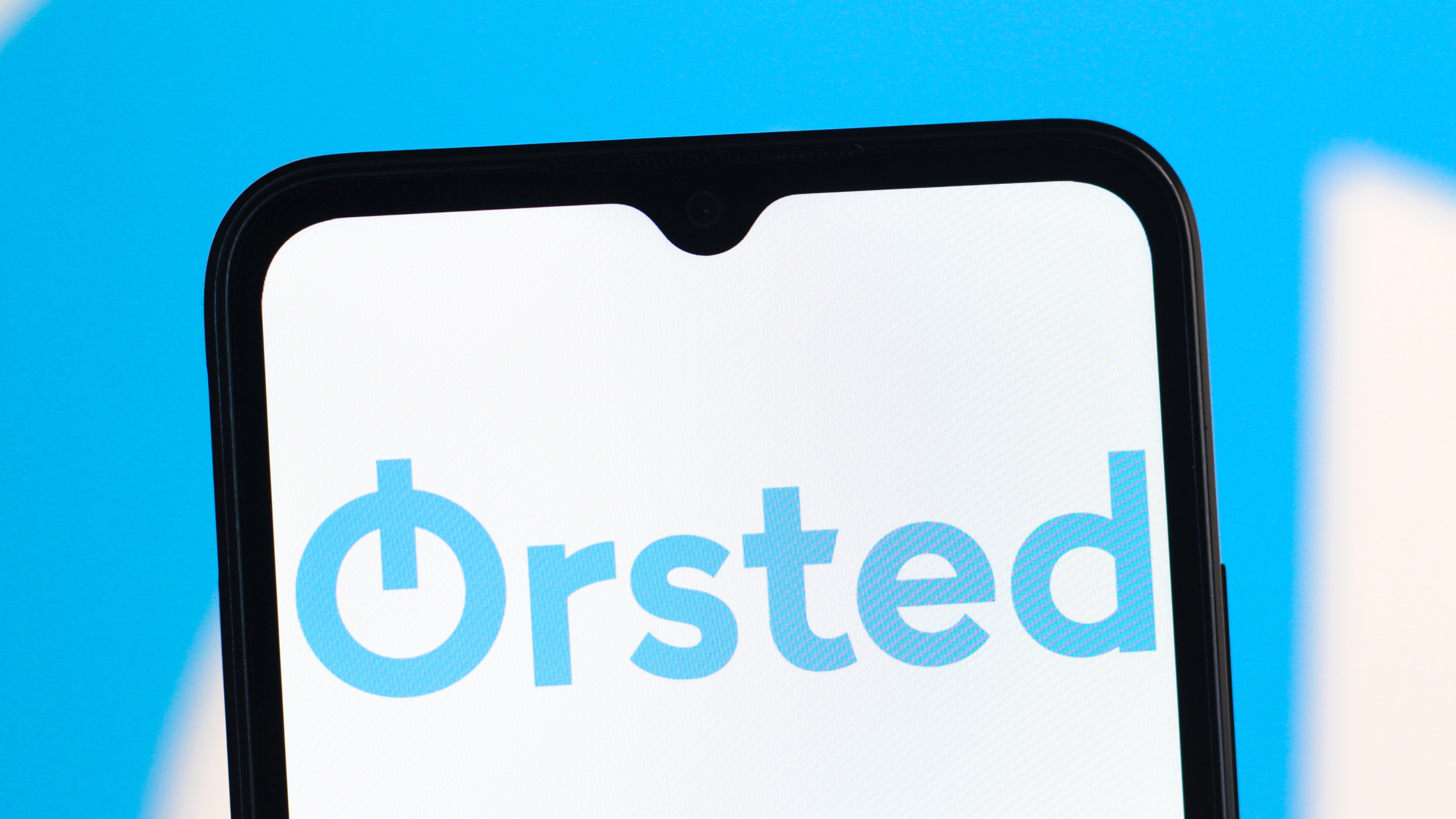 The Orsted logo is seen displayed on a smartphone screen.