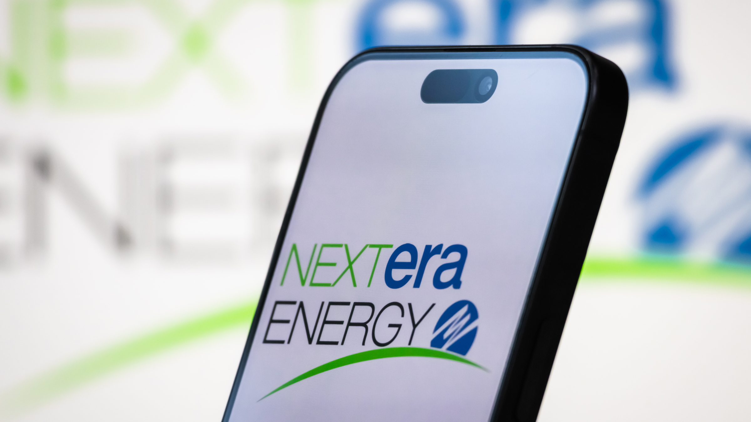 The logo of NextEra Energy, Inc. is displayed on a smartphone screen.
