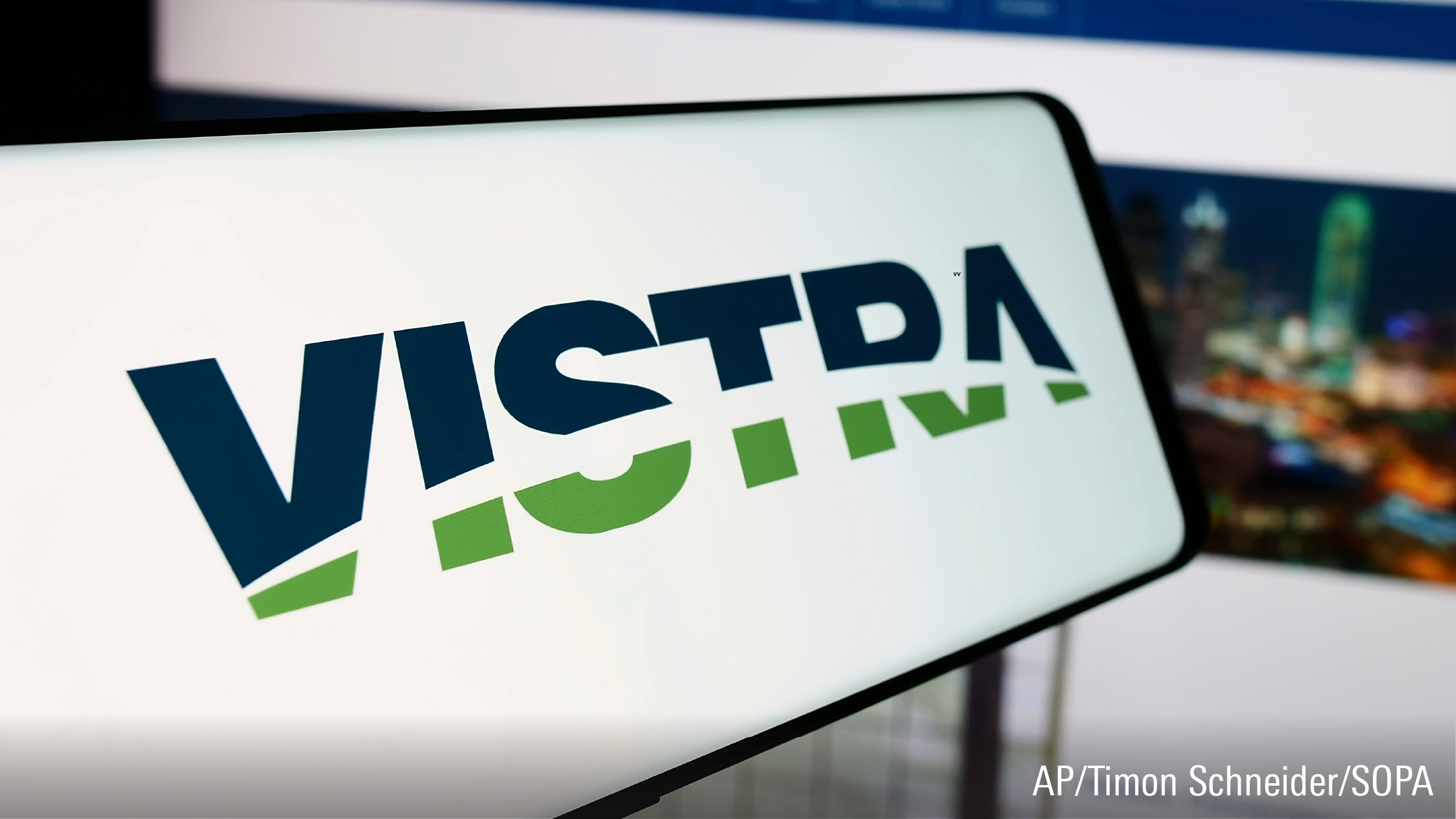 In this photo illustration, a mobile phone with the logo of American energy company Vistra Corp. is seen in front of business website.