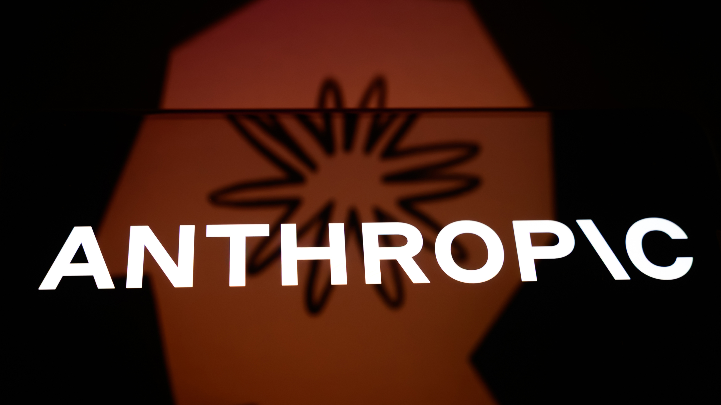 The Anthropic logo is displayed on a smartphone screen.
