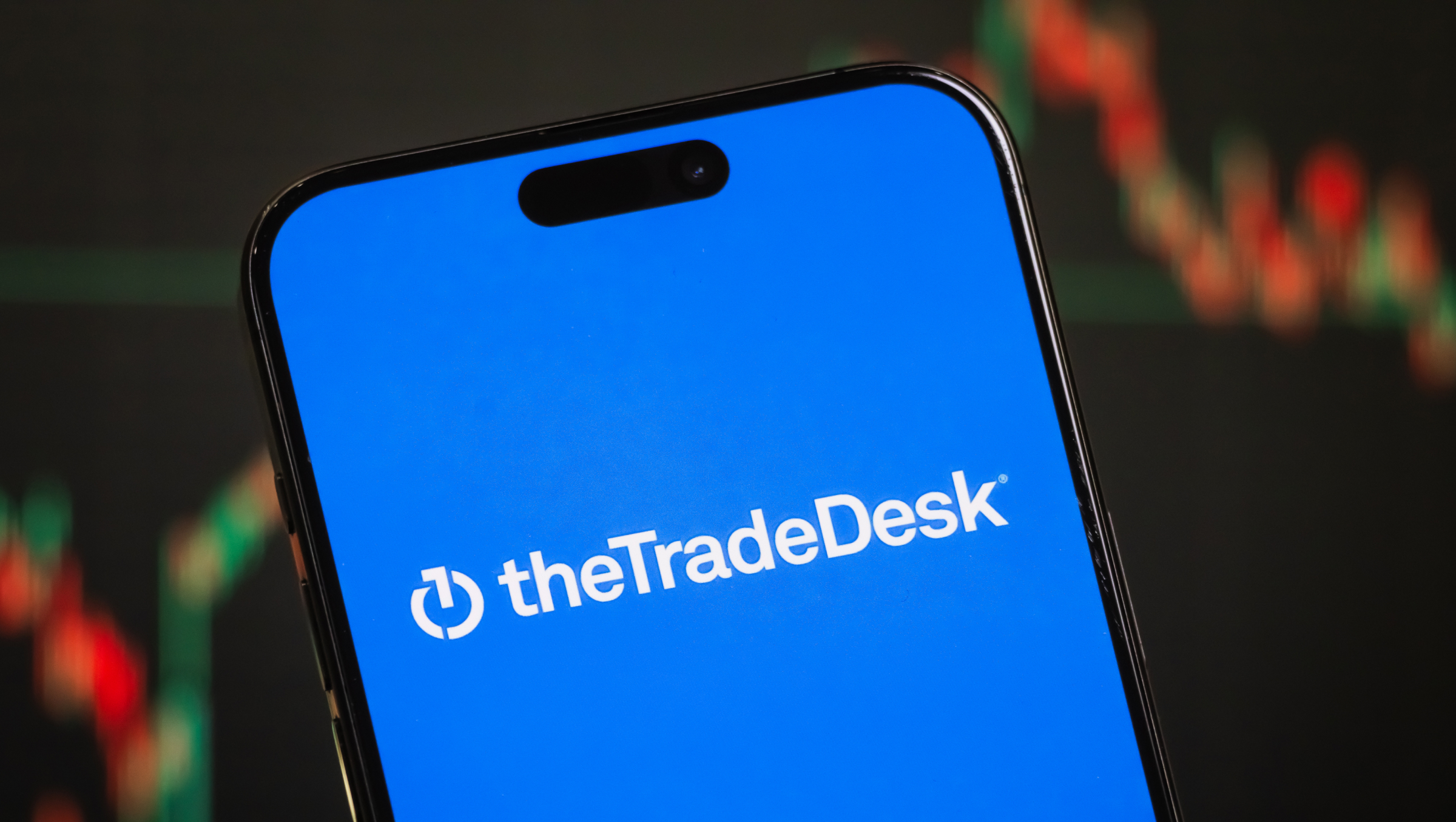The Trade Desk logo is displayed on a smartphone screen.
