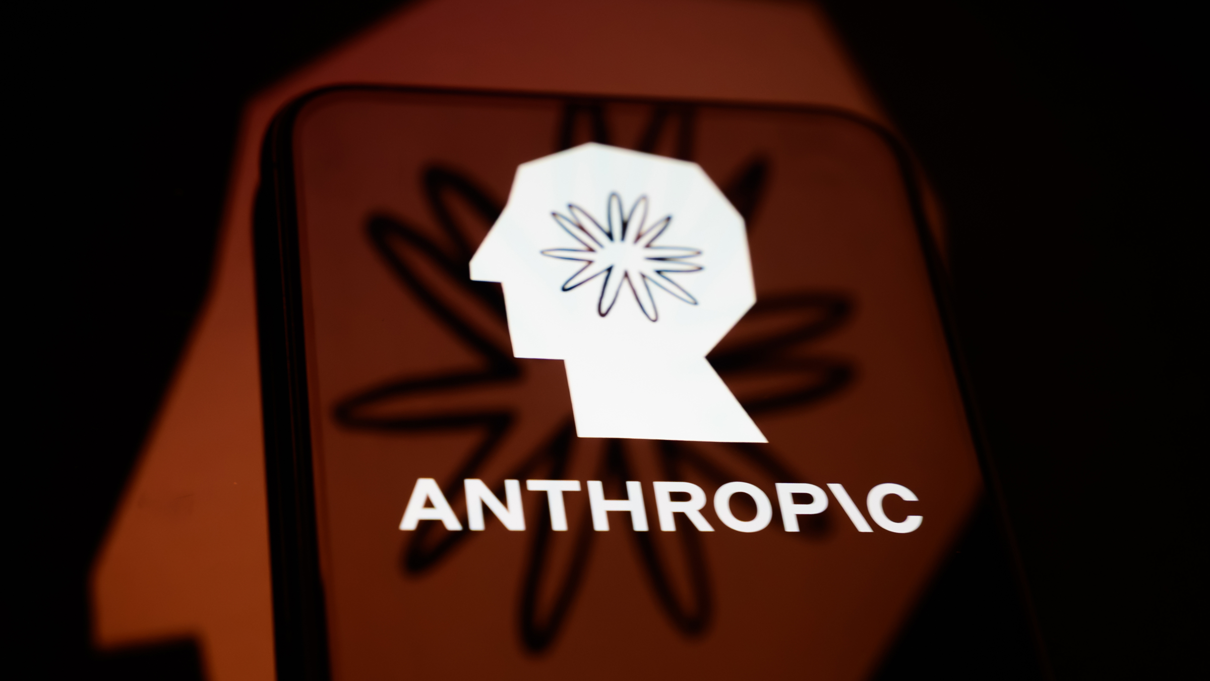 The Anthropic logo is displayed on a smartphone screen.