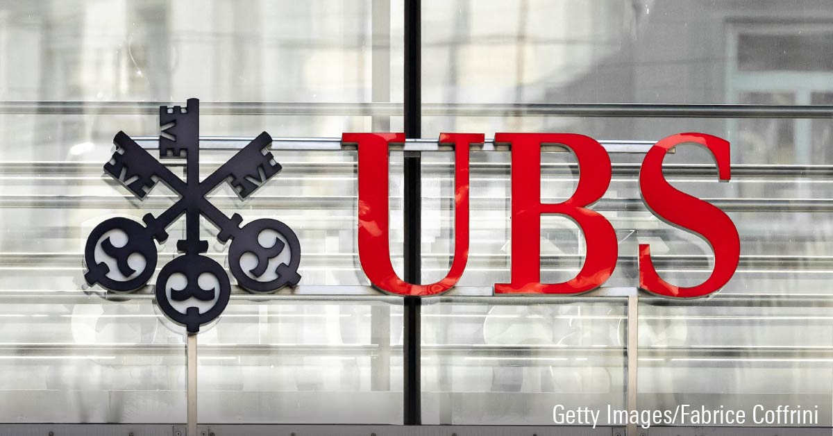 A sign and logo of UBS bank on building