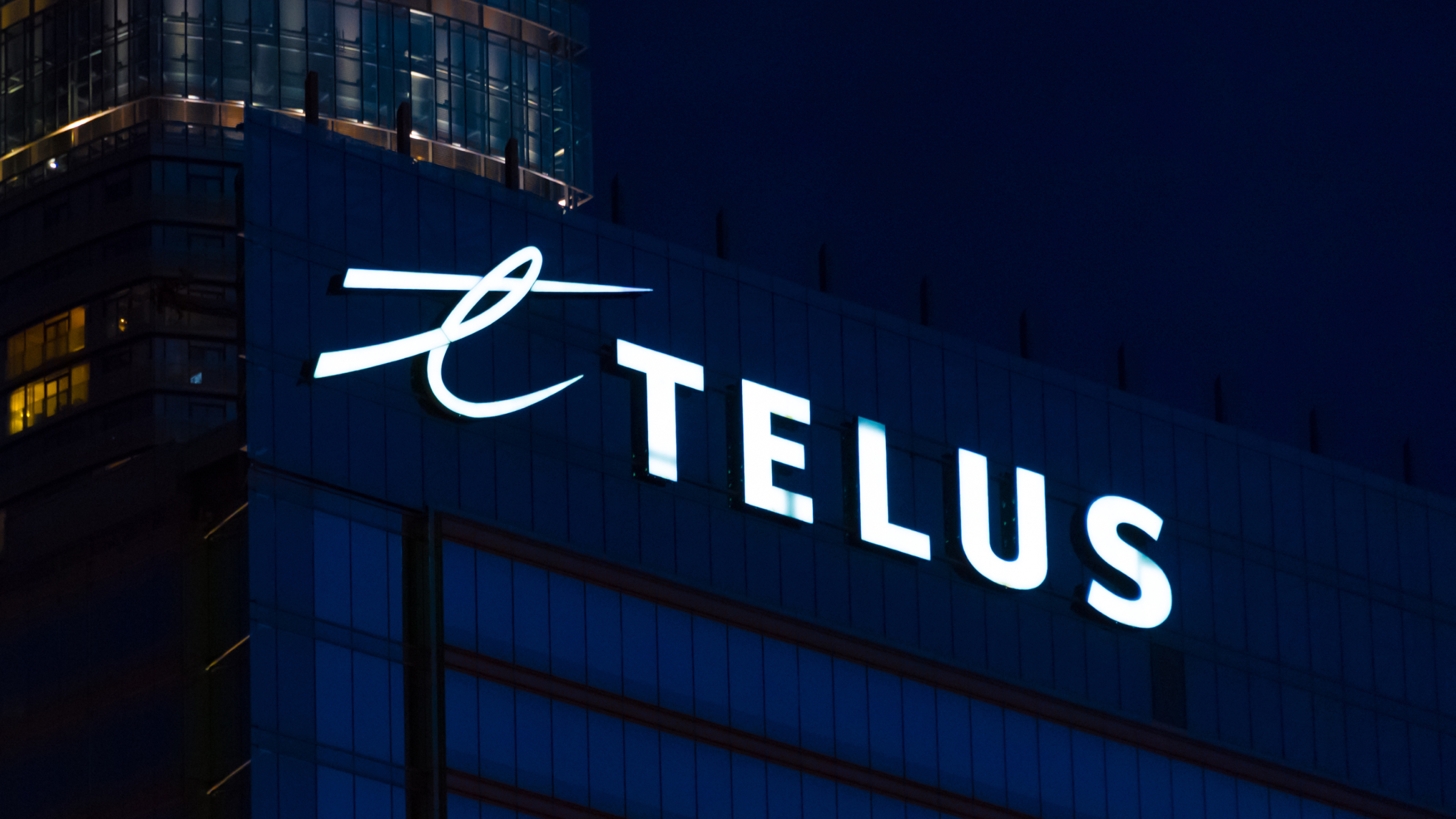 Telus logo sign in downtown building.
