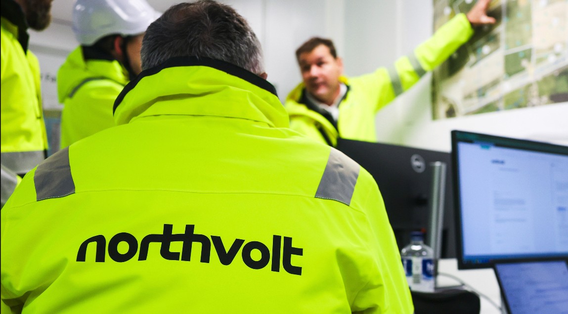 Northvolt employees talk in a planning office on a construction site