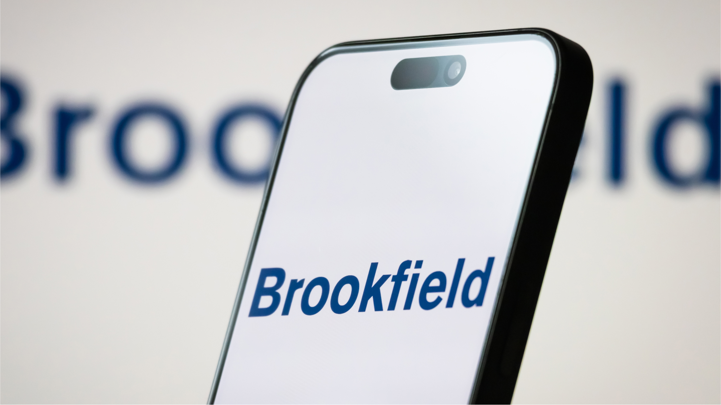 The logo of Brookfield Corporation is displayed on a smartphone screen.