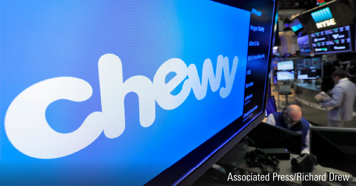 The logo for Chewy appears above trading posts on the floor of the New York Stock Exchange.