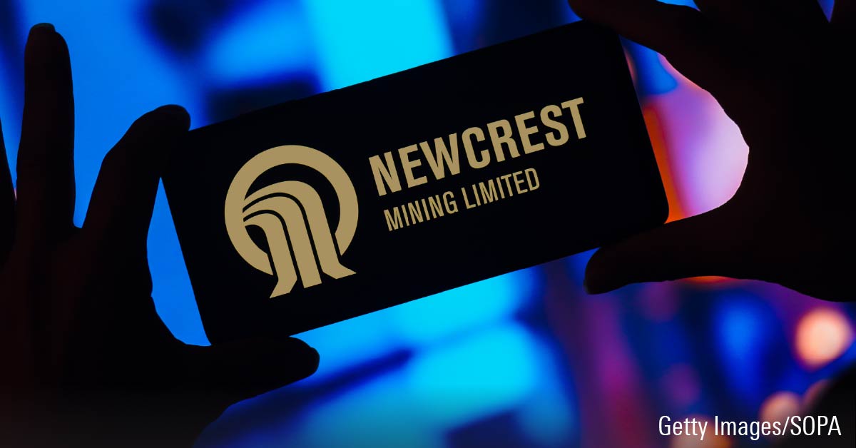 The Newcrest Mining Limited logo is displayed on a smartphone screen.
