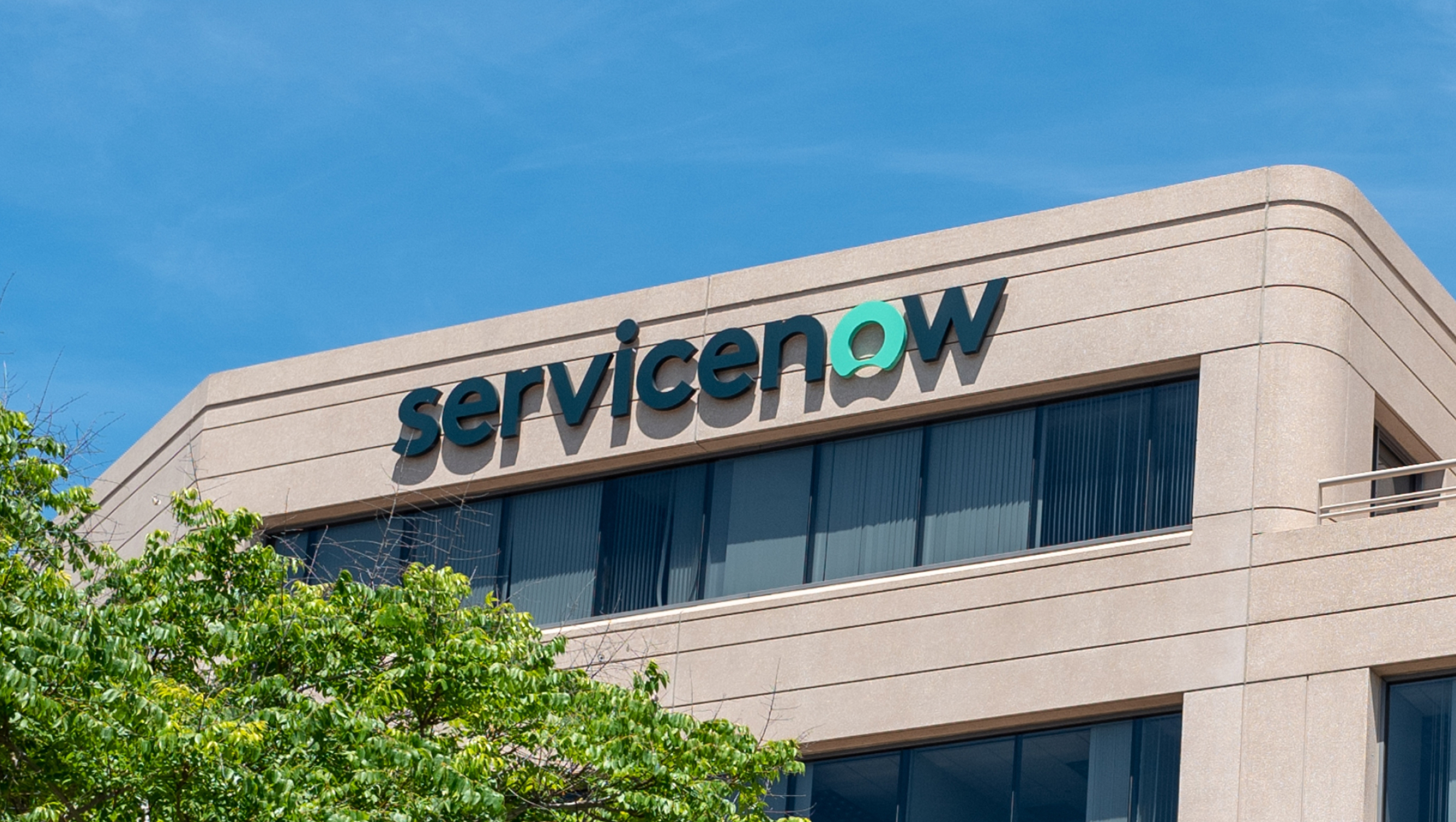 Low-angle view of facade with sign and logo at office.