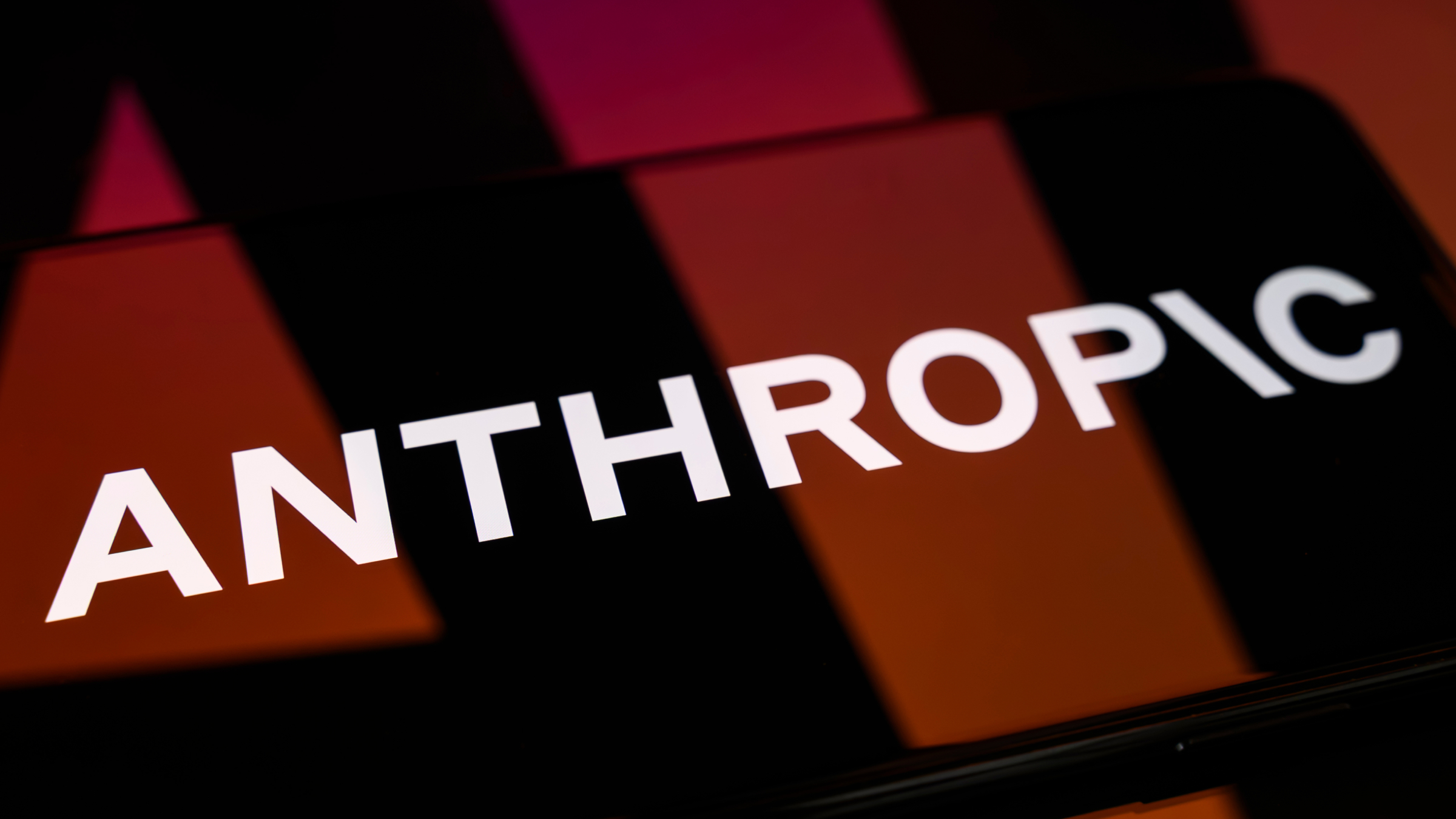 The Anthropic logo is displayed on a smartphone screen.