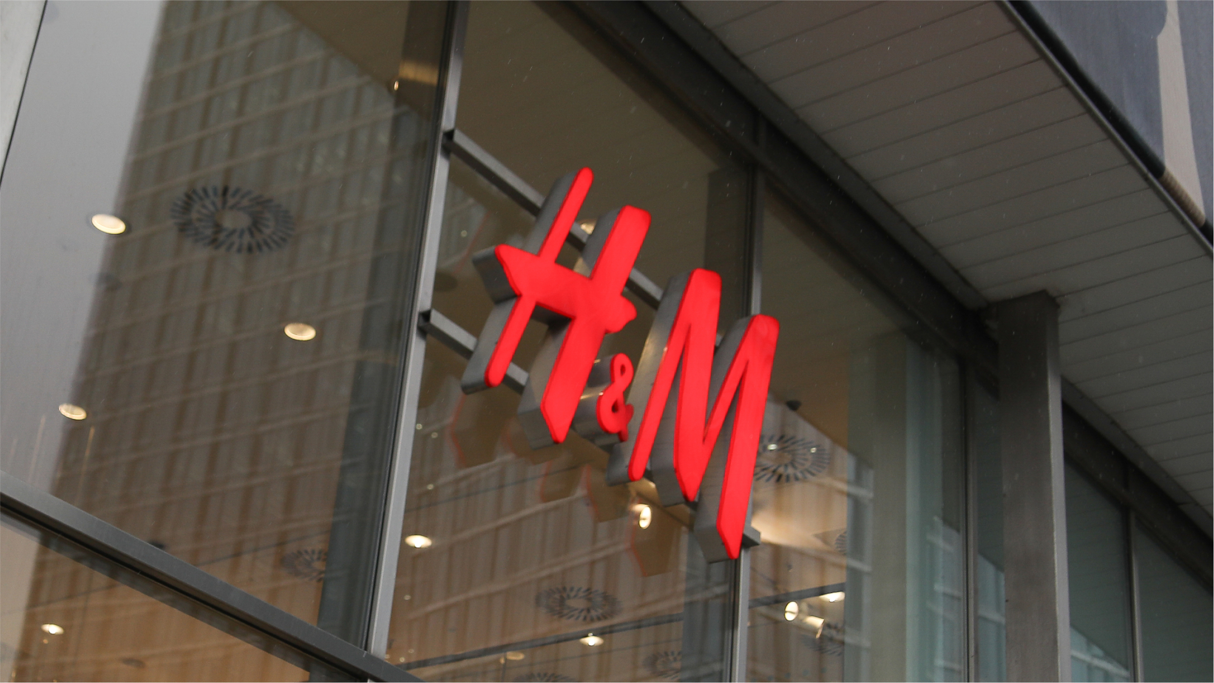 The H&M logo is seen on the street.