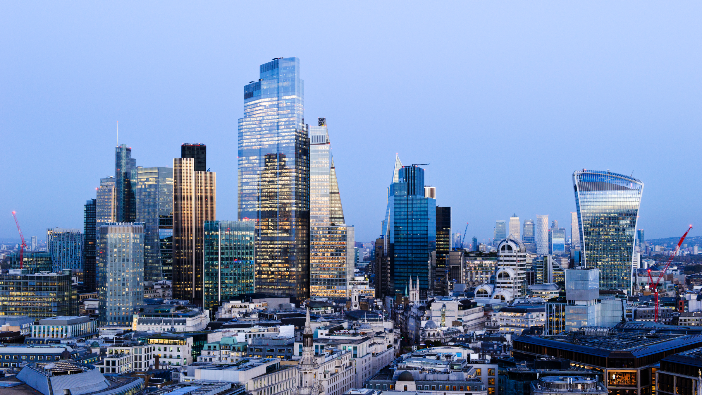 UK, London, elevated view over city financial district skyline looking west illuminated at dusk