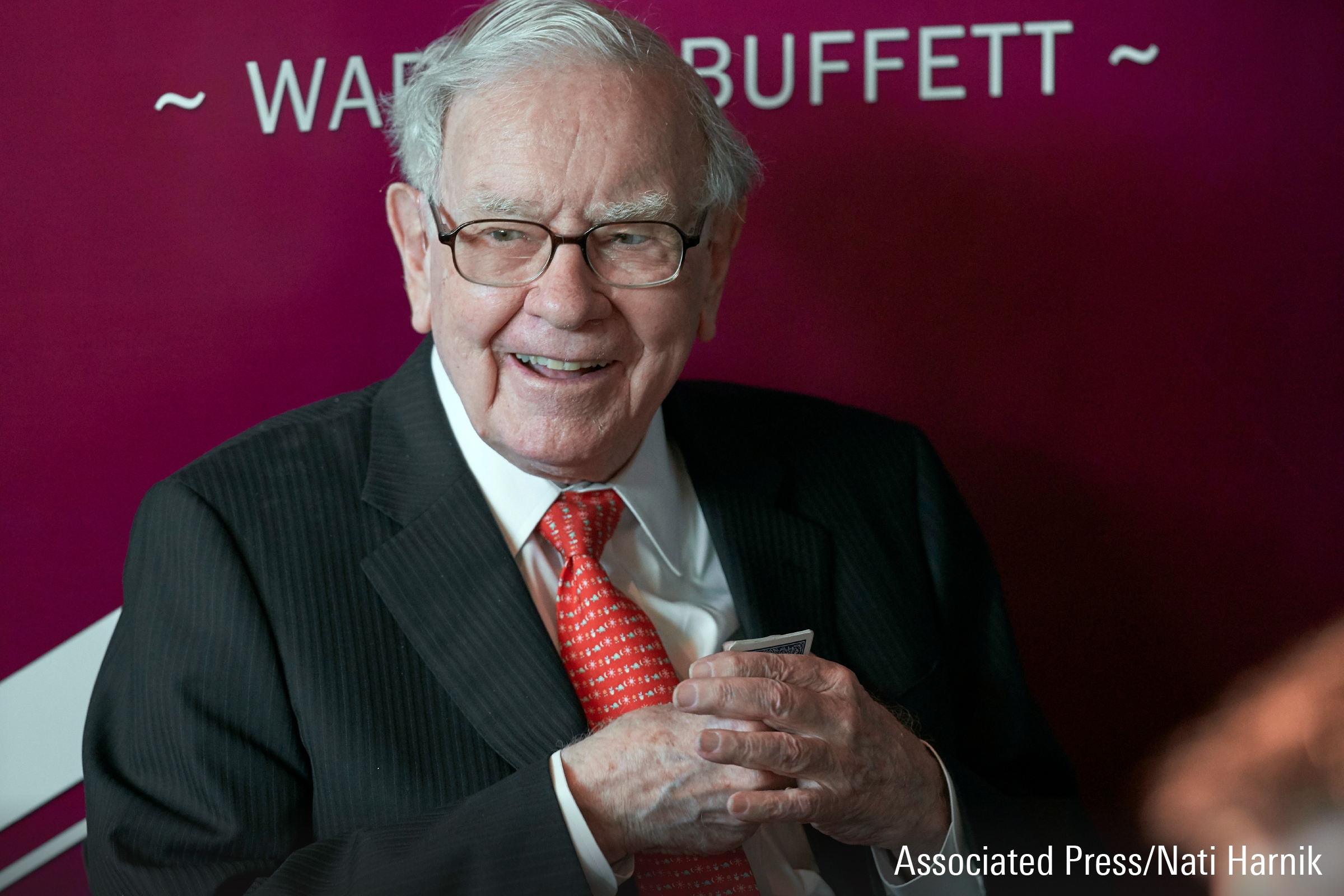 A photograph featuring Warren Buffett speaking at an event.