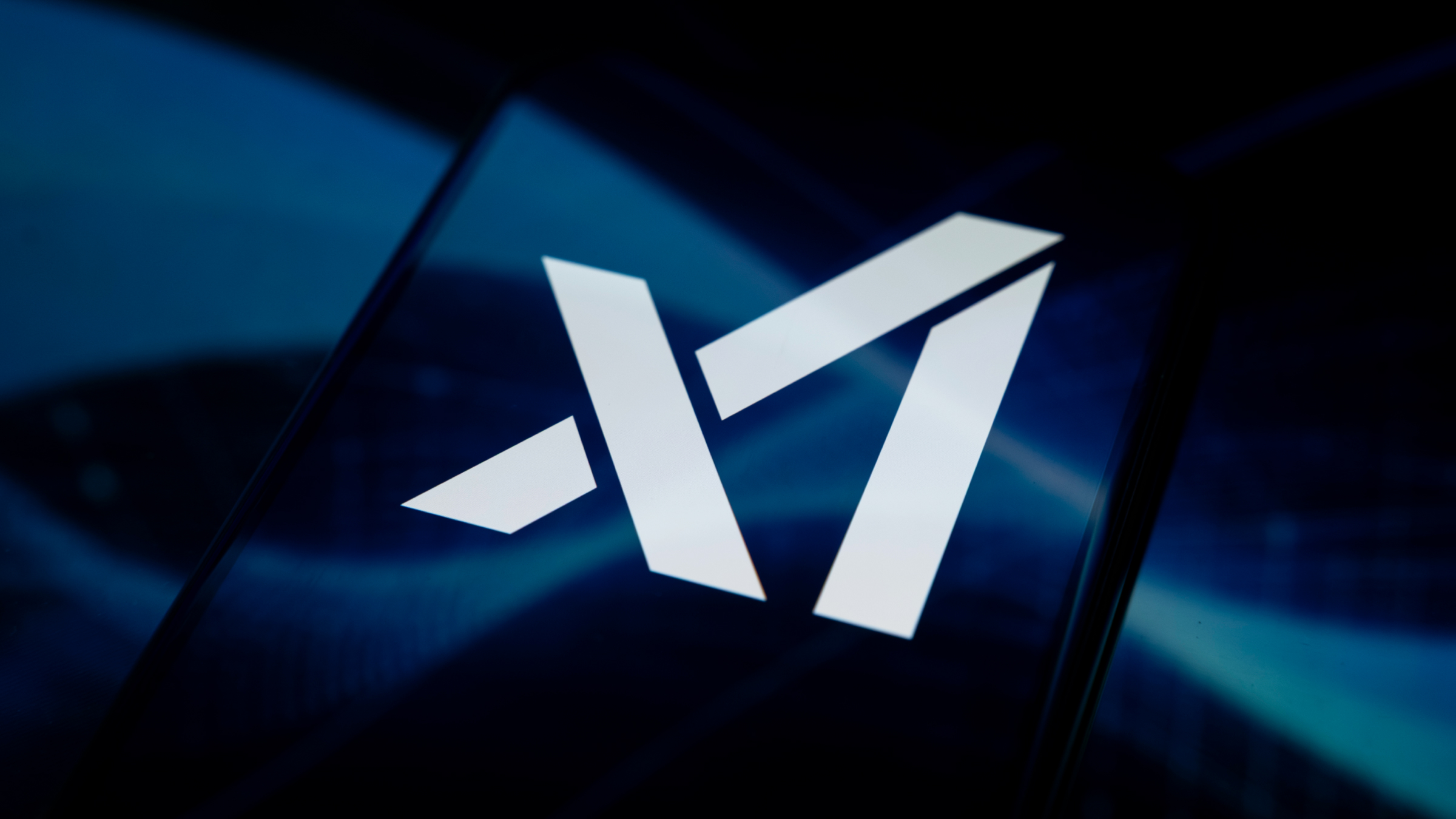 The xAI logo is displayed on a smartphone screen.