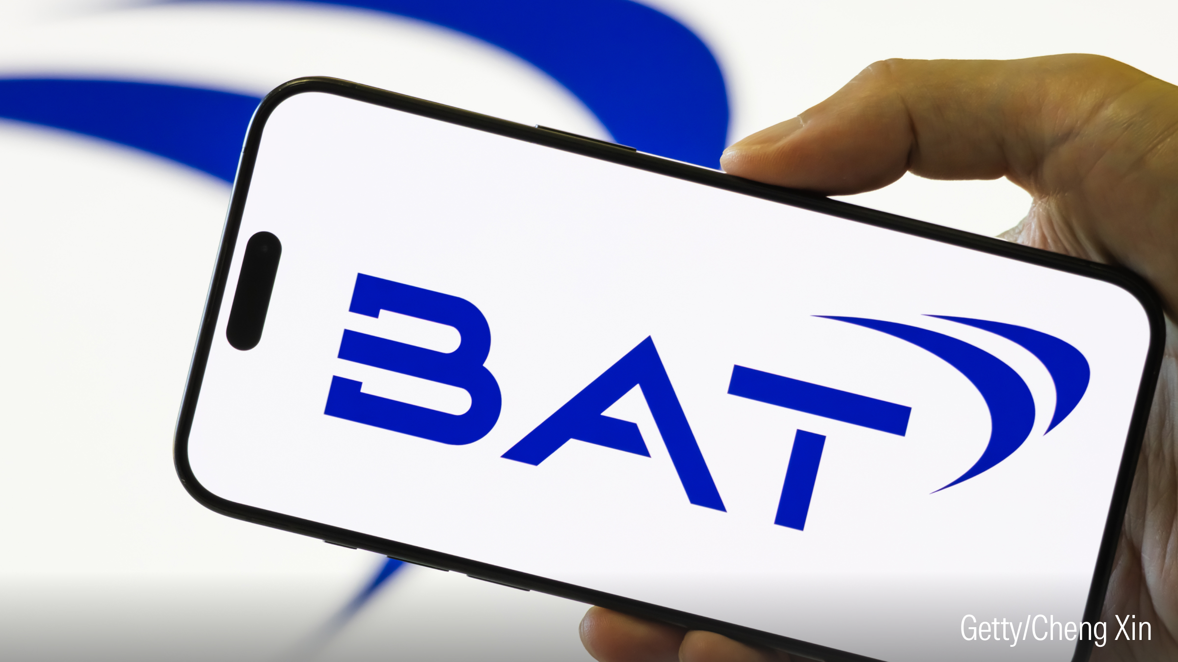 A smartphone held in a hand shows the logo of British American Tobacco Plc.