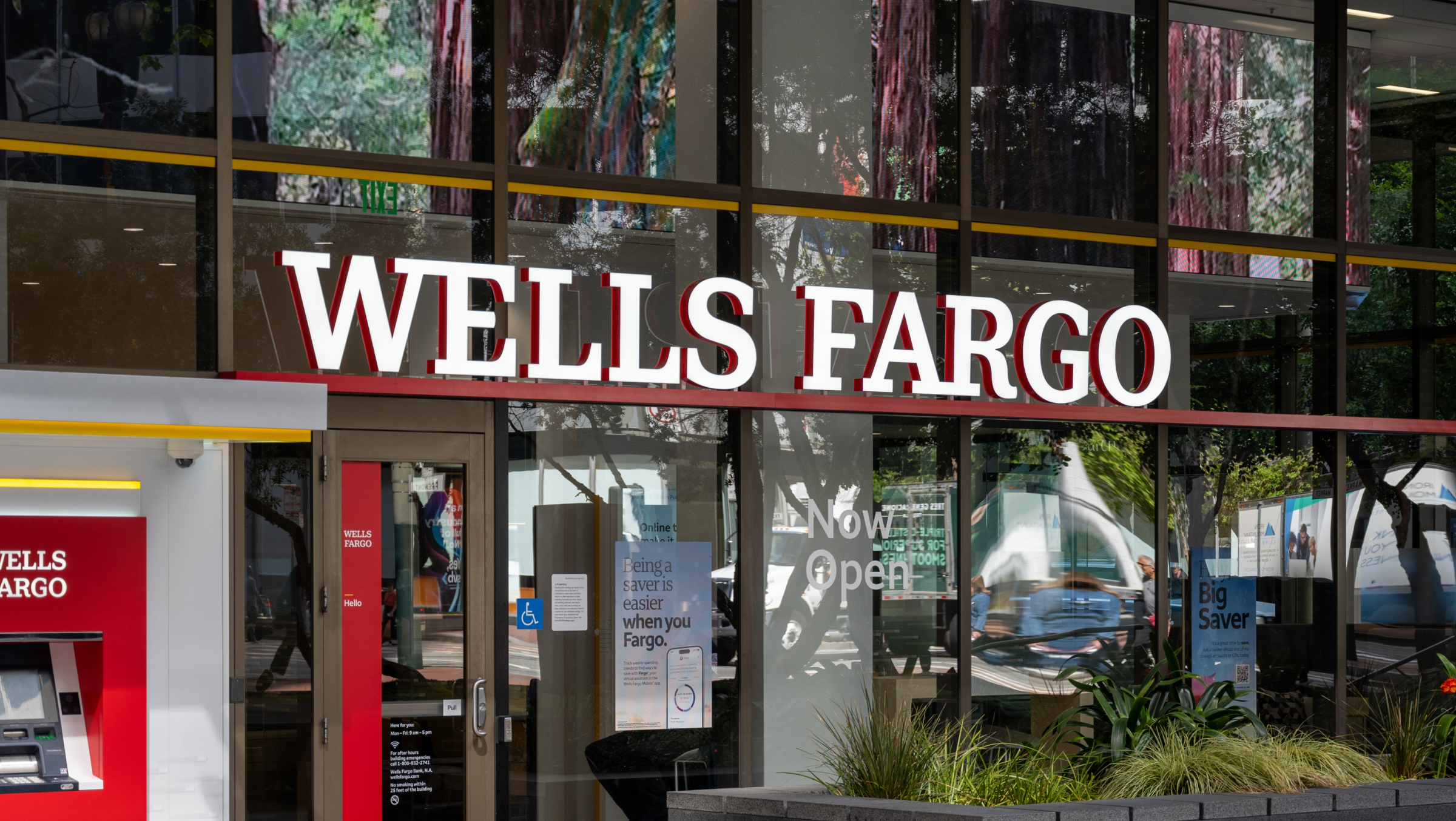 Facade of Wells Fargo bank branch with visible ATM and signage.