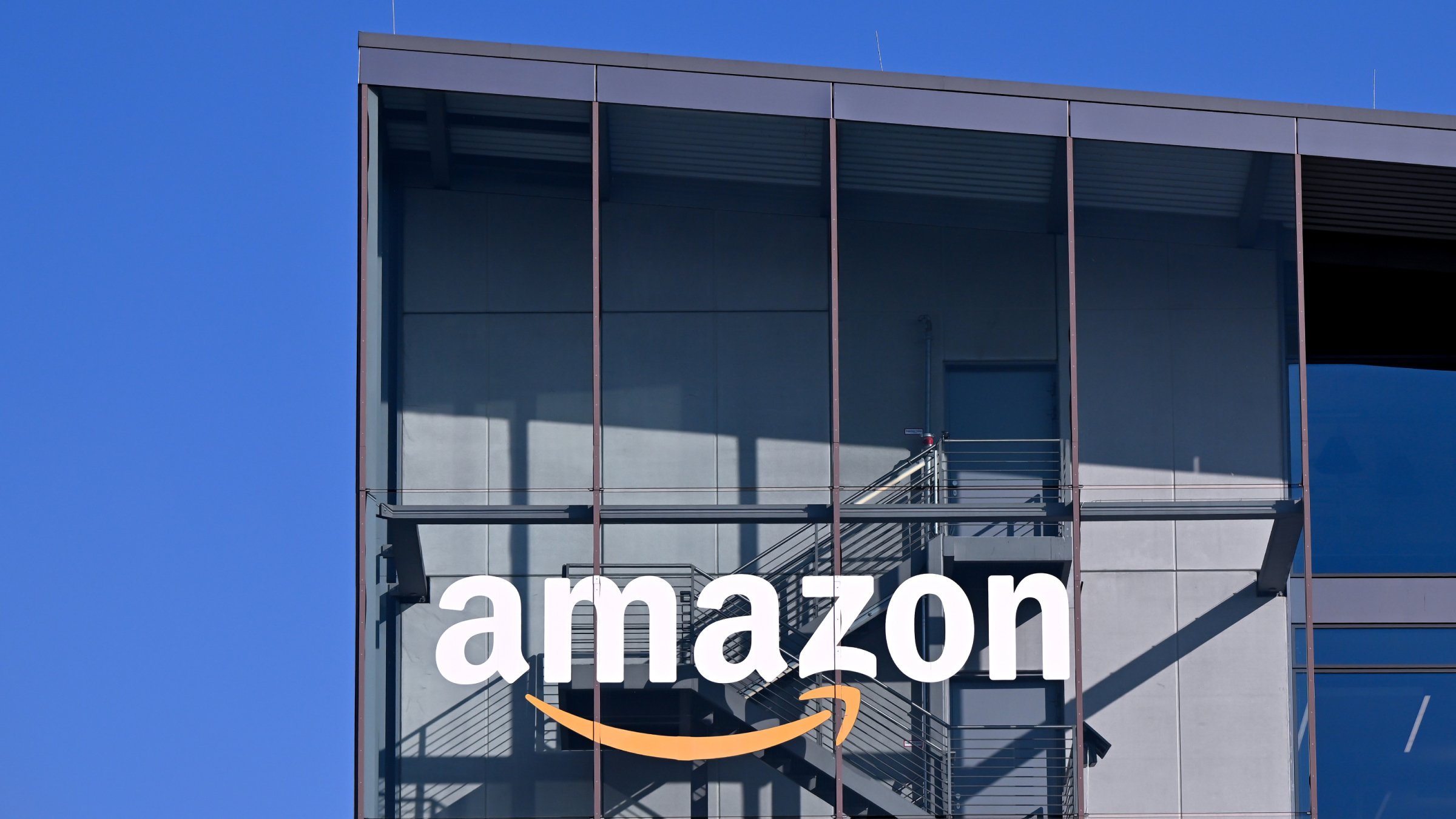 The Amazon logo on a facade of a headquarter building.