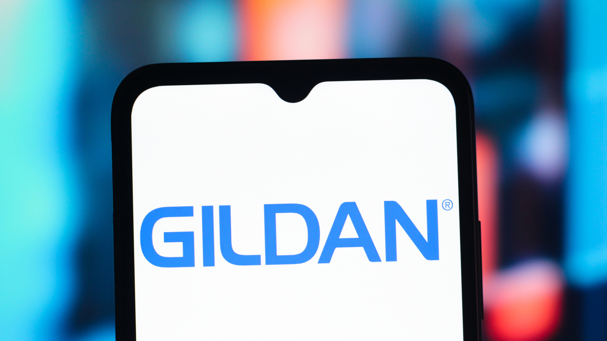 The Gildan Activewear company logo is seen displayed on a smartphone screen.