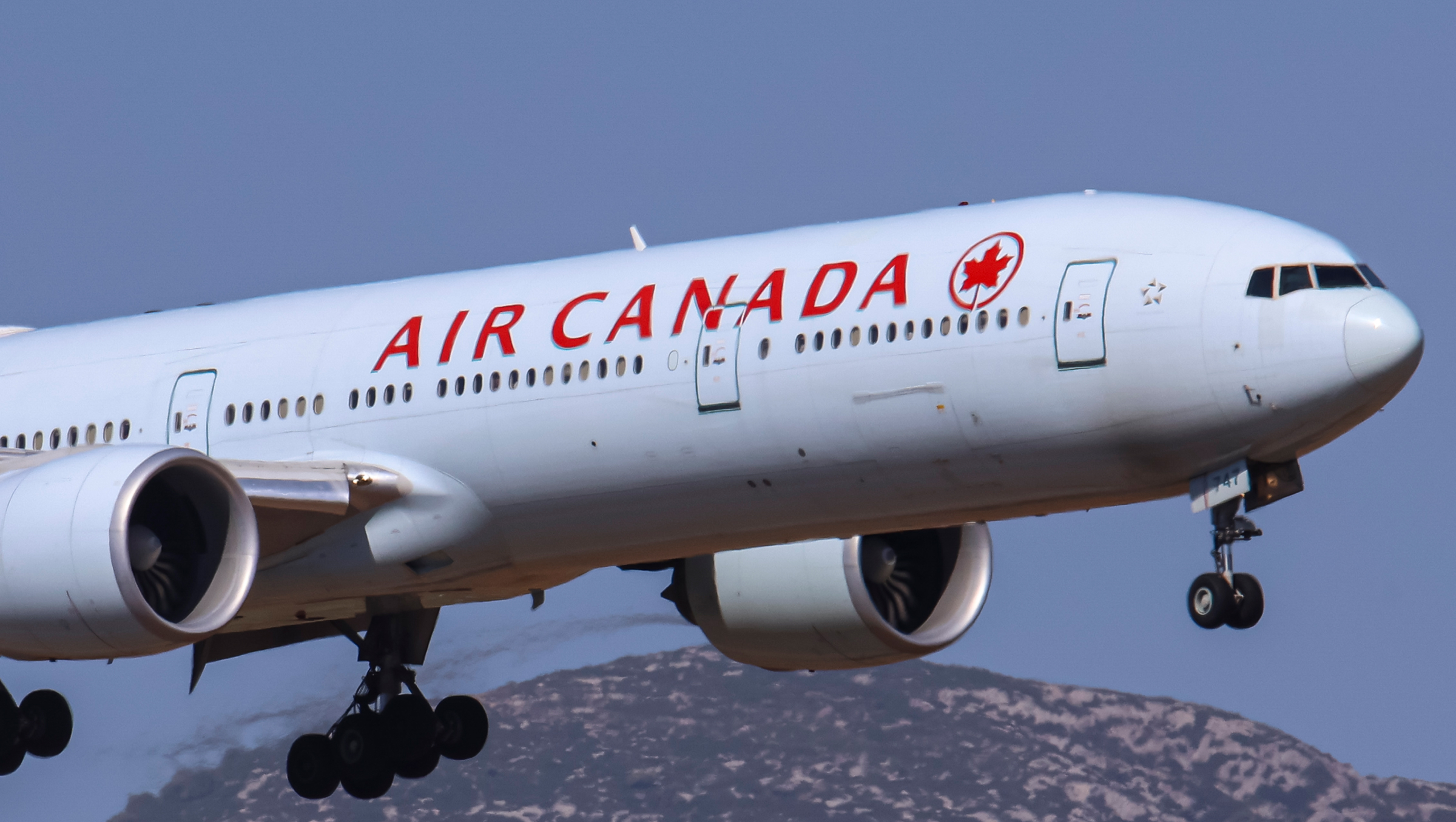 An Air Canada plane taking off into the sky.