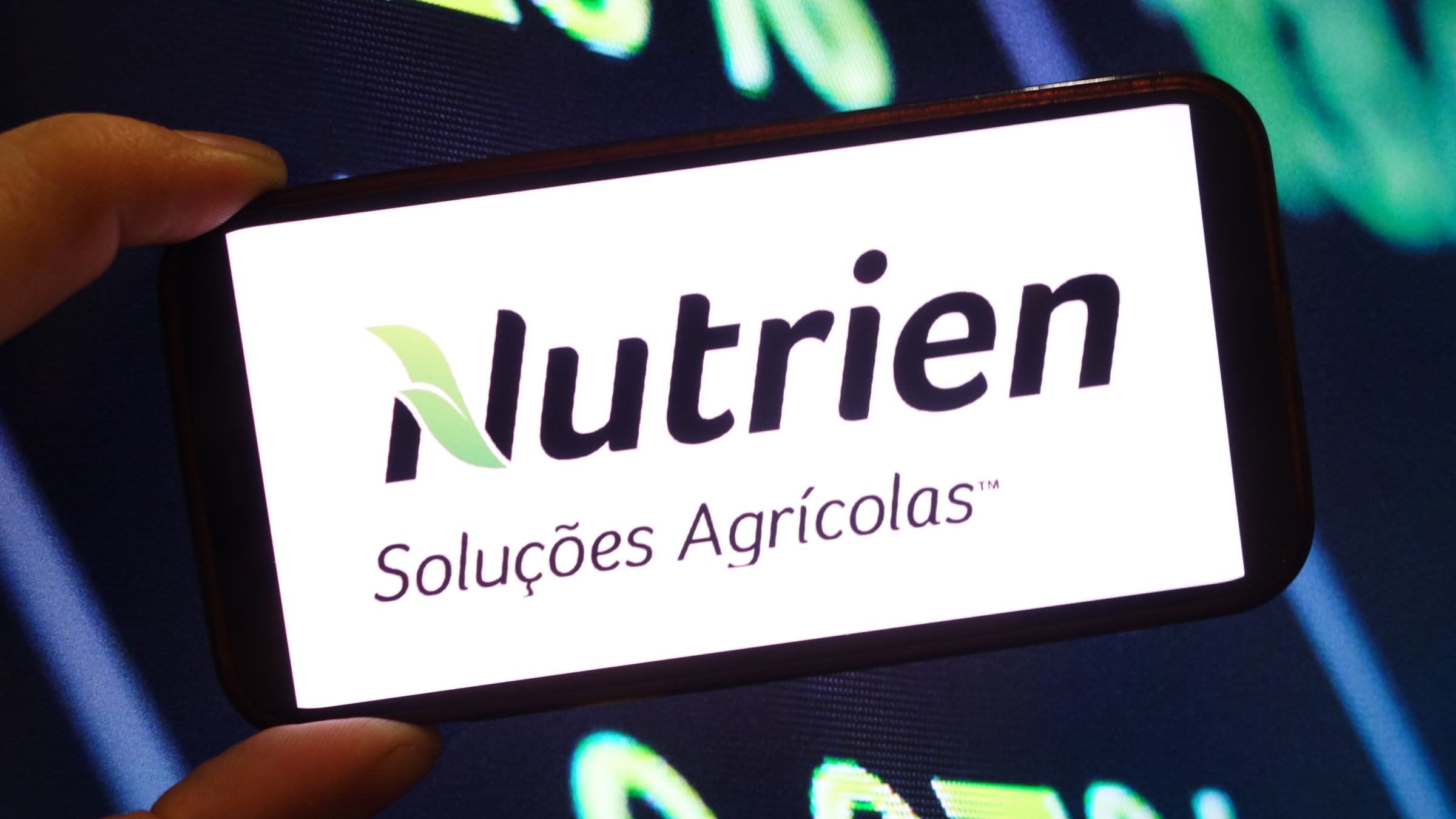 The Nutrien company logo is seen displayed on a smartphone screen.