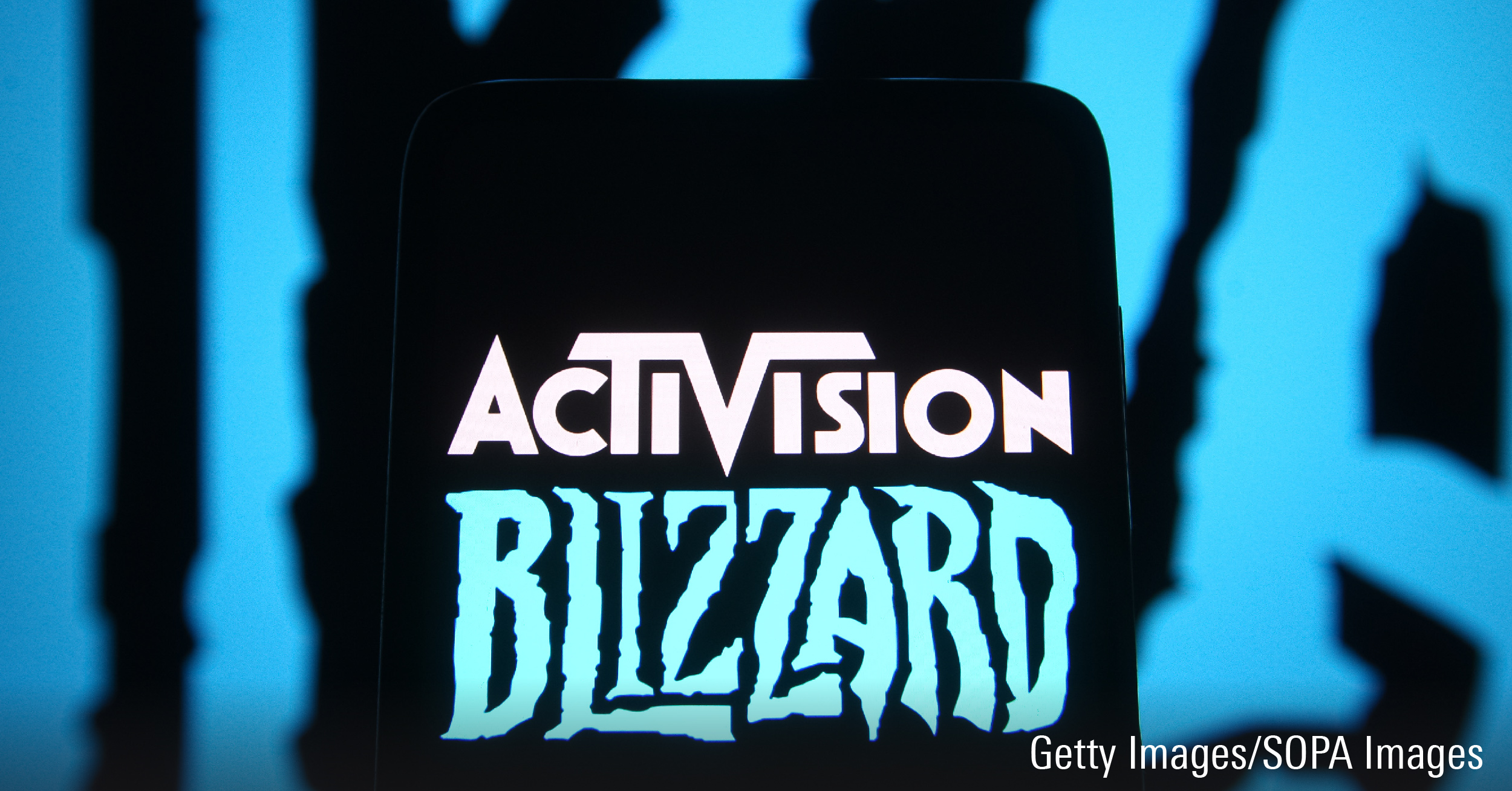 In this photo, Activision Blizzard logo of a video game company is seen on a smartphone screen in front of Blizzard Entertainment logo.