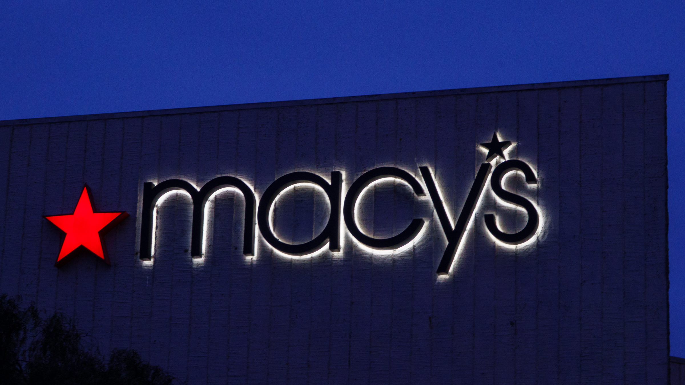 A Macy's logo is displayed outside a department store.