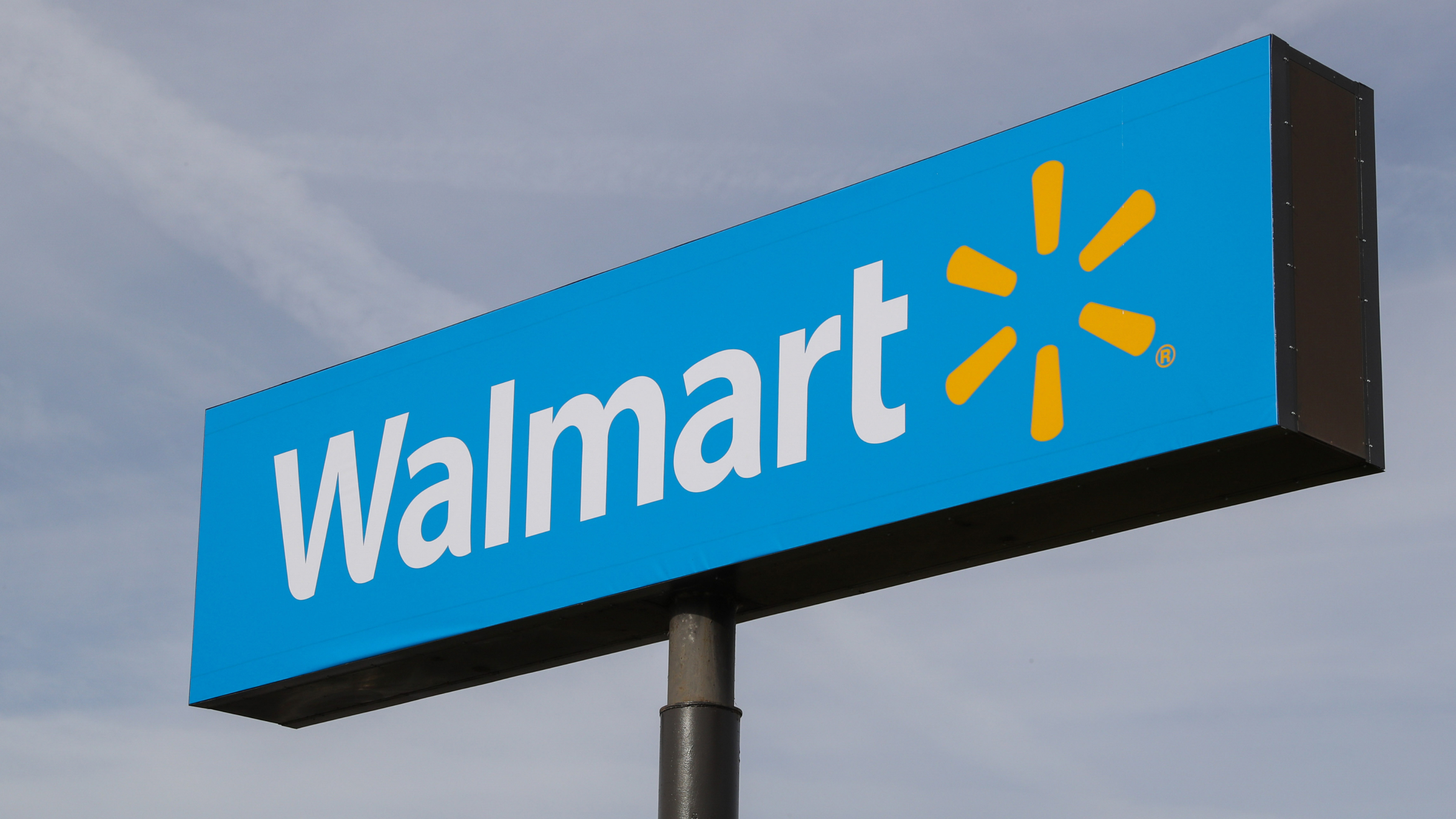A sign with the Walmart logo is seen outside of a Walmart store.
